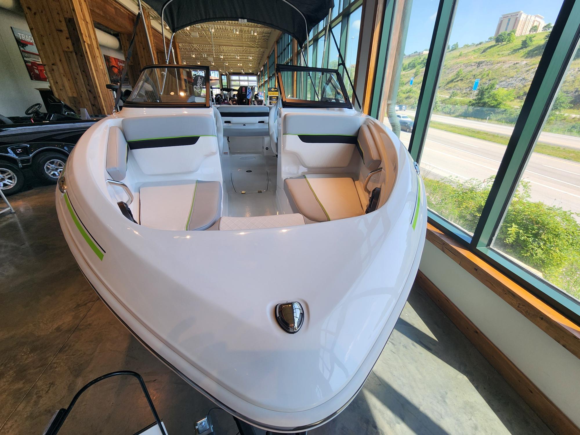 2024 Tahoe 210 Si boat displayed indoors with modern seating and sleek design.