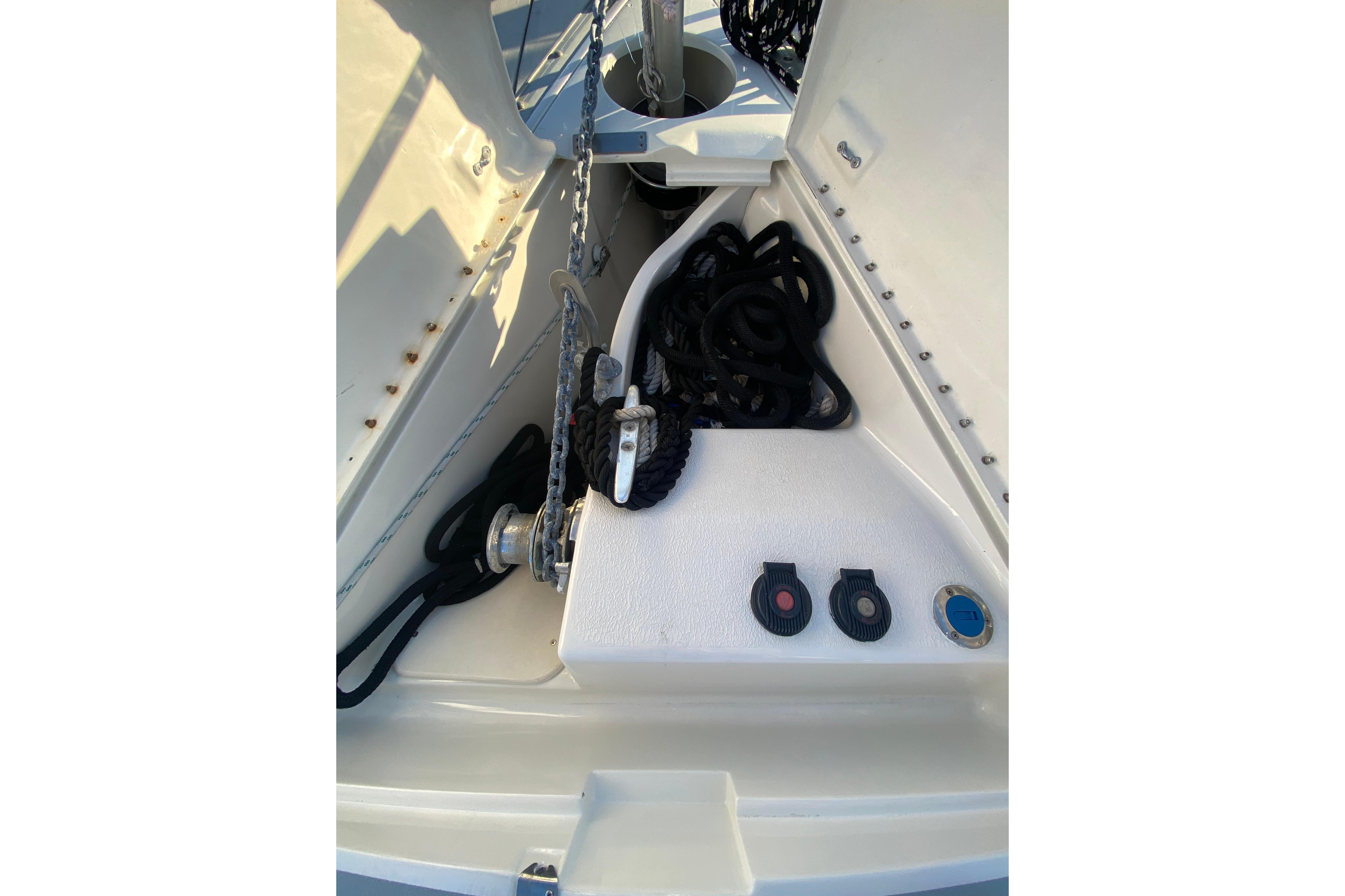 Anchor locker of 1997 Hunter Legend 40.5 sailboat with ropes and winch.