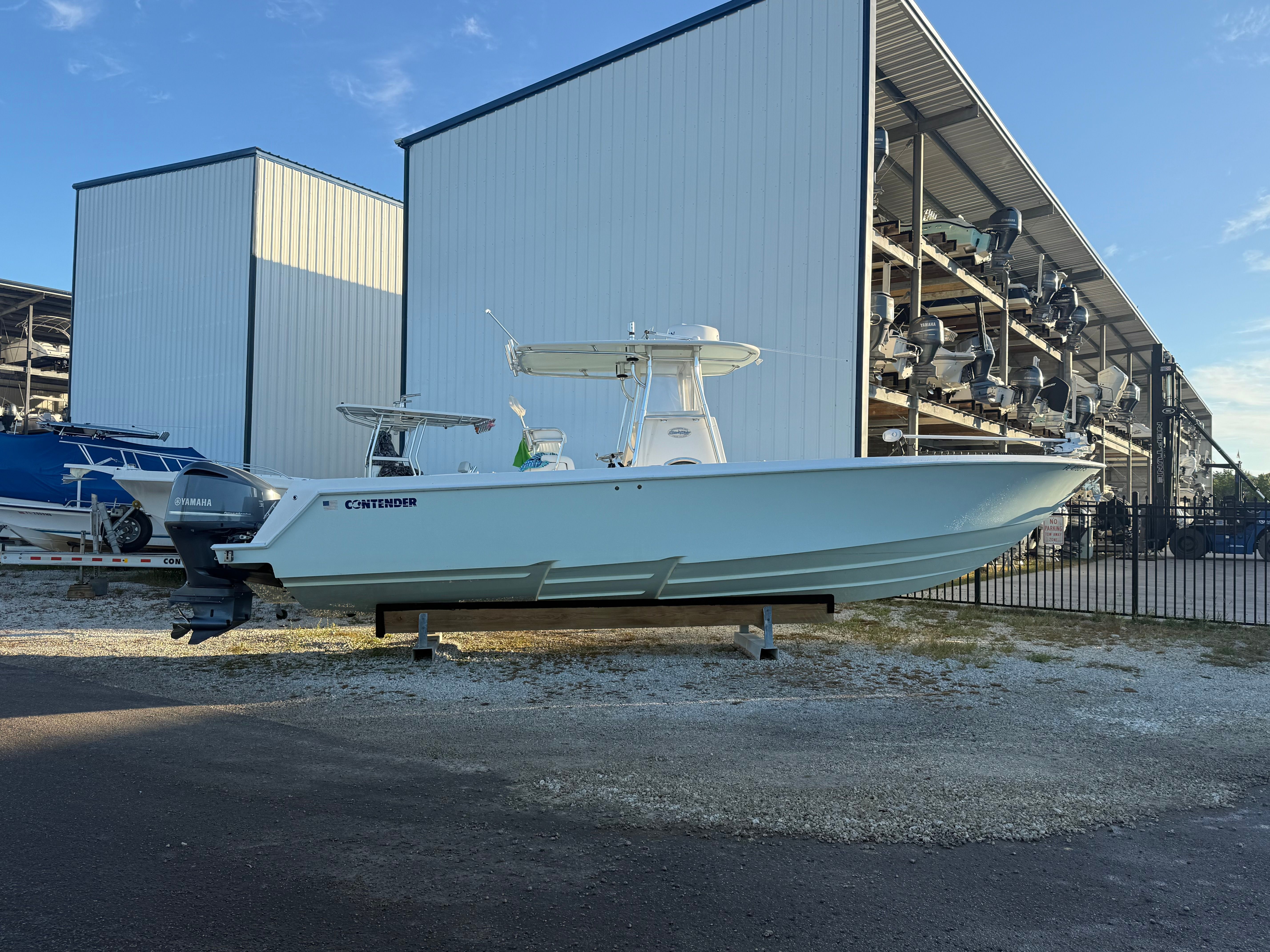 2012 Contender 32 ST boat in front of storage building.