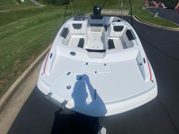 2024 Tahoe 2150 boat, white interior, parked on a paved road.