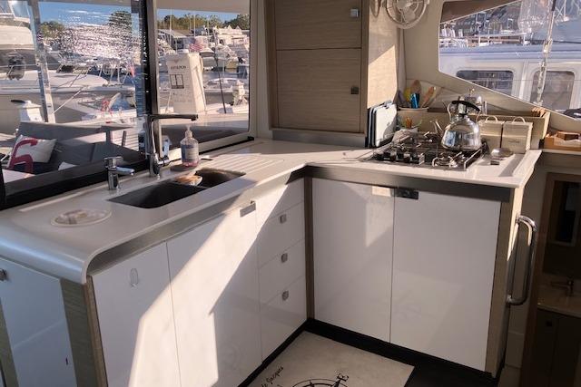 Modern kitchen in 2021 Fountaine Pajot Isla 40 catamaran with stove and sink.