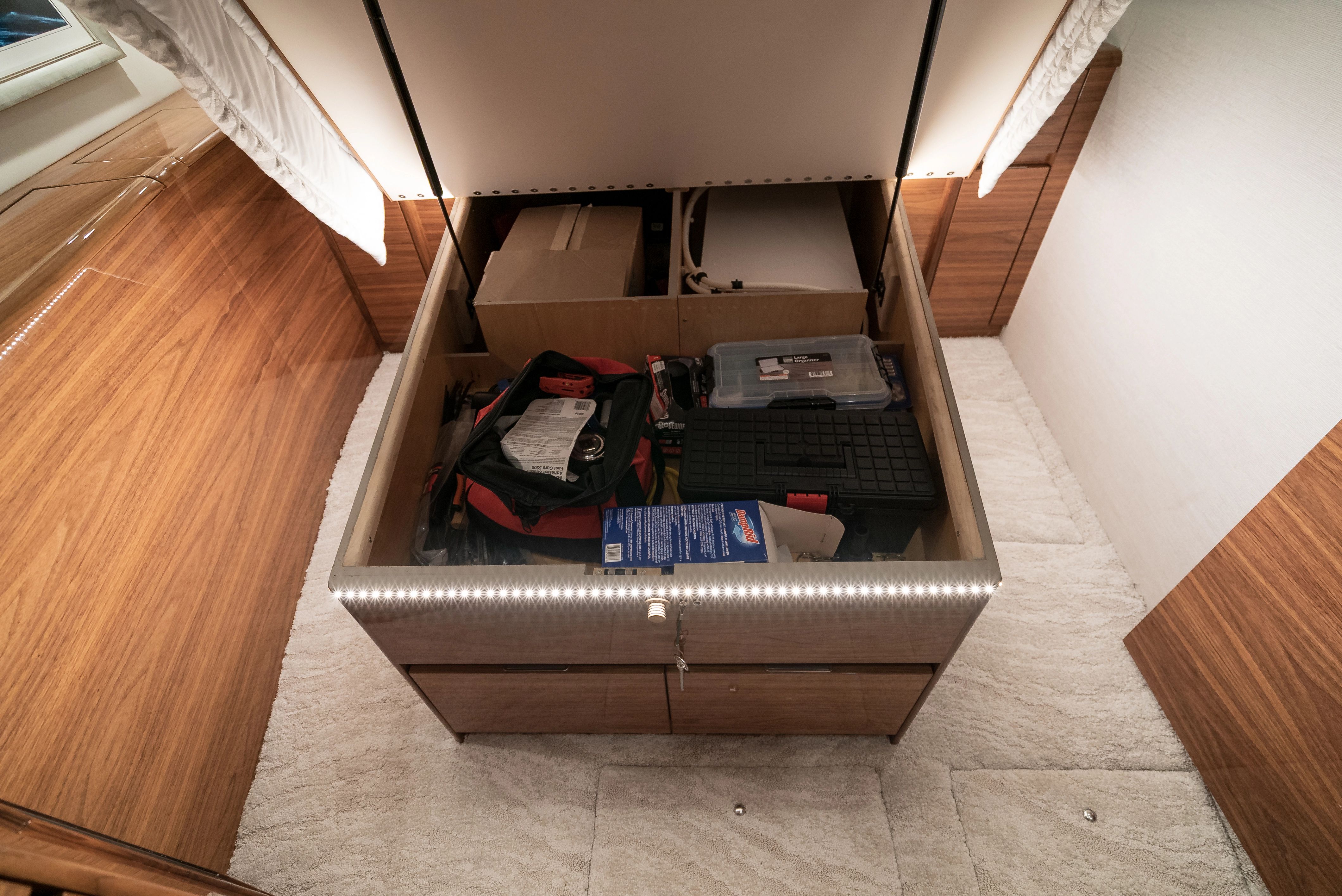 Storage compartment in 2025 Viking 48 Convertible with tools and accessories.