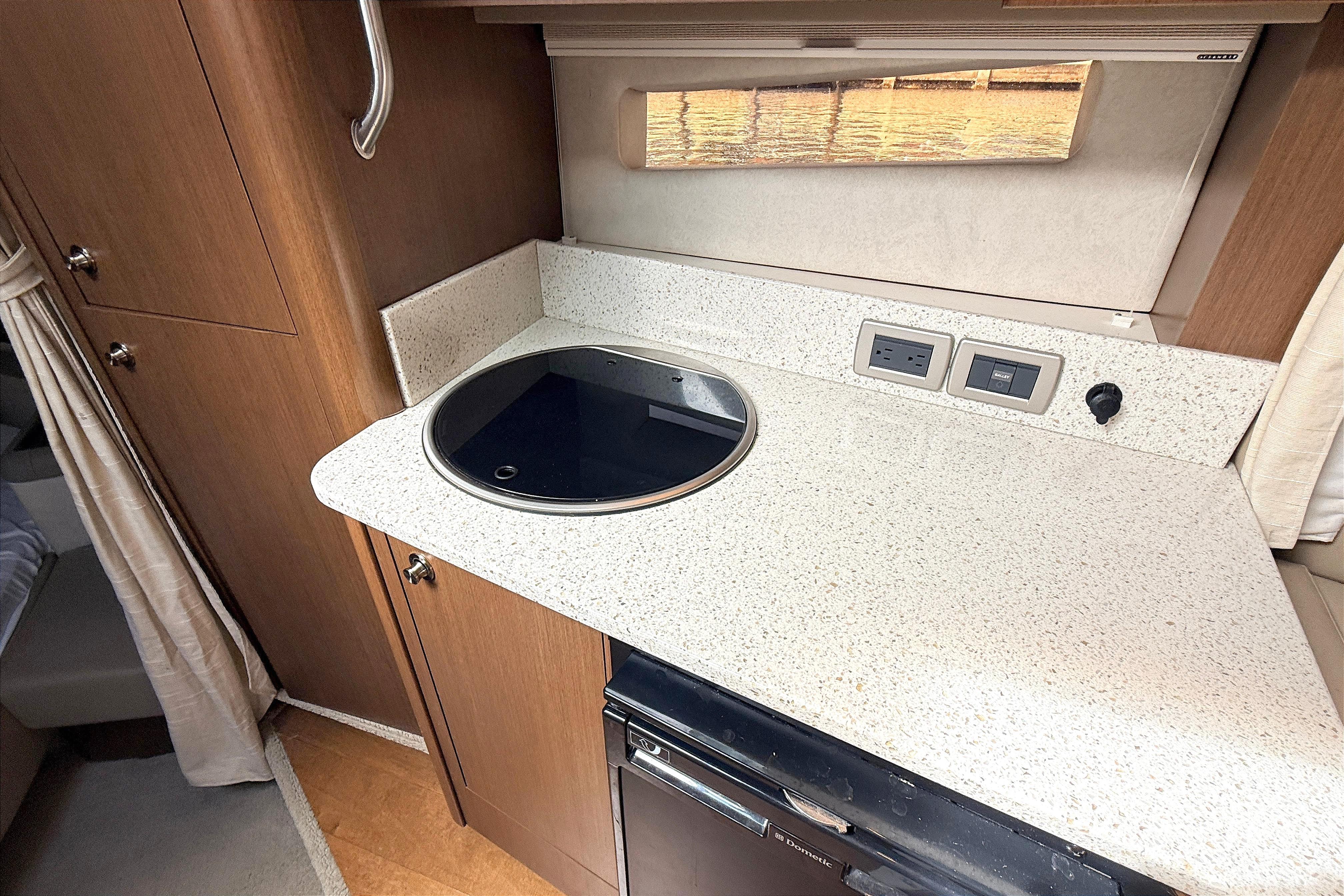 2013 Sea Ray 370 Venture kitchen area with stovetop and countertop.