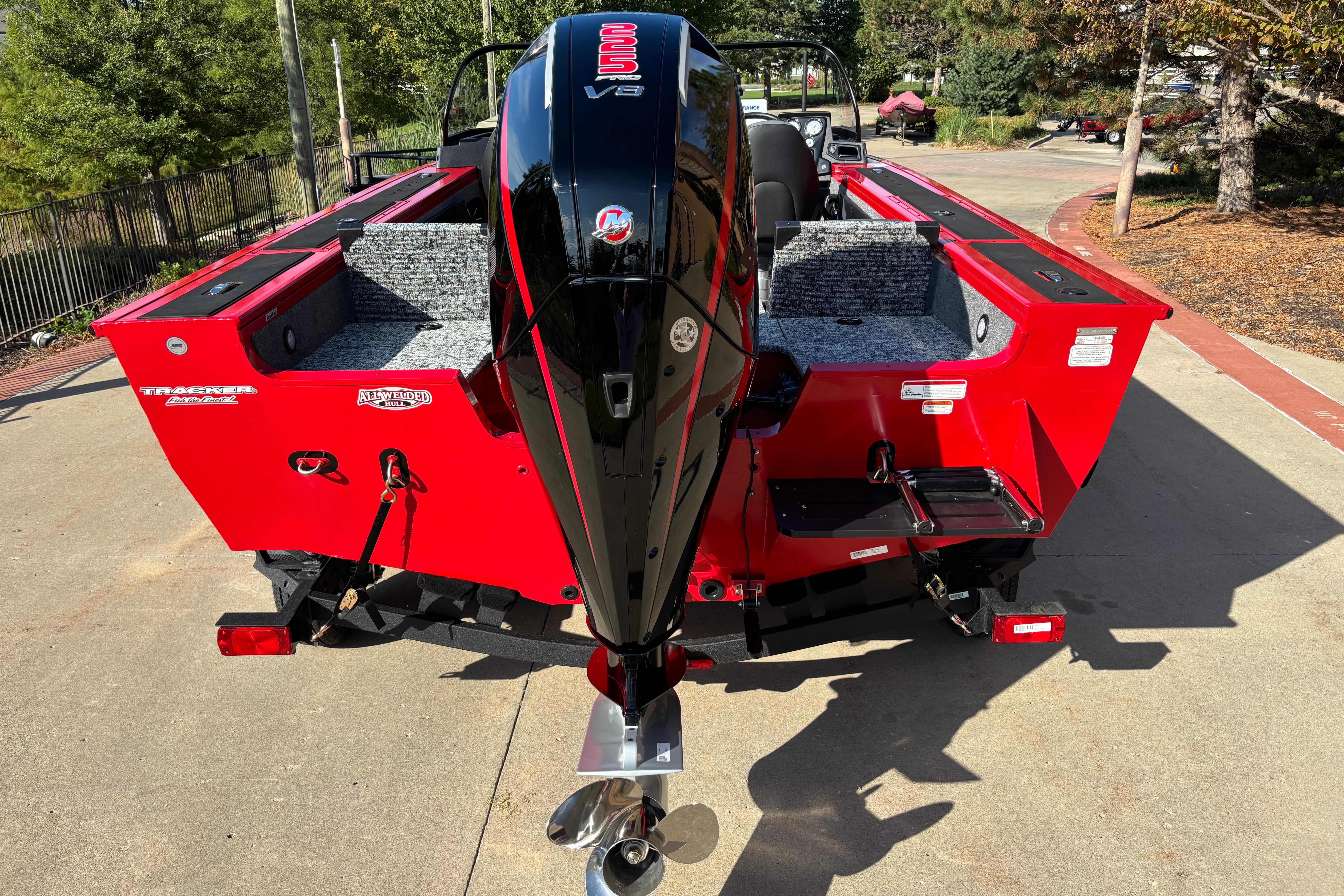 2026 Tracker Targa V-19 Combo boat with powerful outboard motor, parked outdoors.