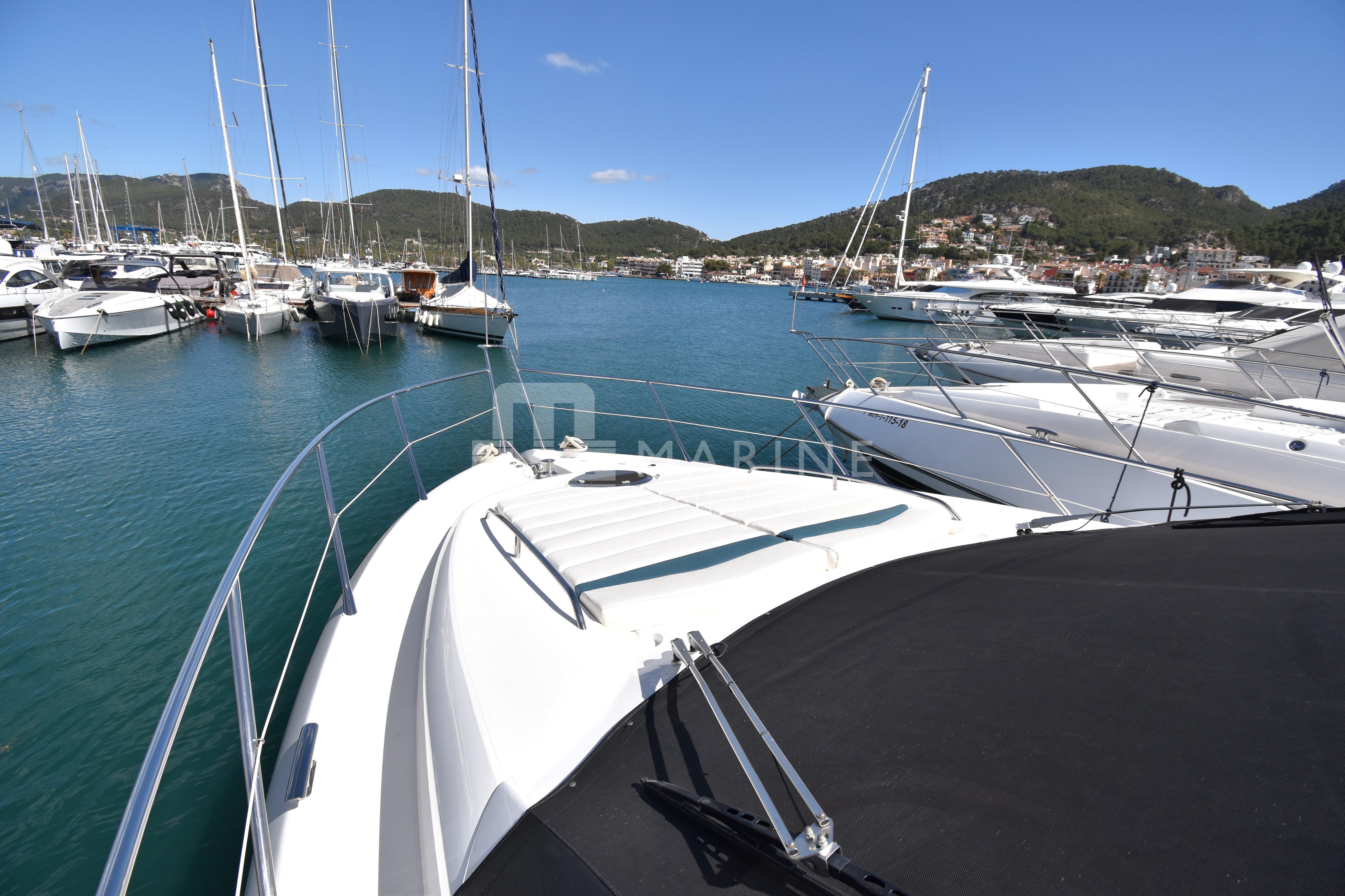 Sunseeker Manhattan 52 yacht docked in a scenic marina, 2010 model.