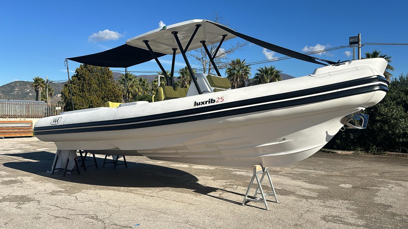 Aqvaboats Luxrib 25, 2026 model, white inflatable boat with canopy, displayed outdoors.