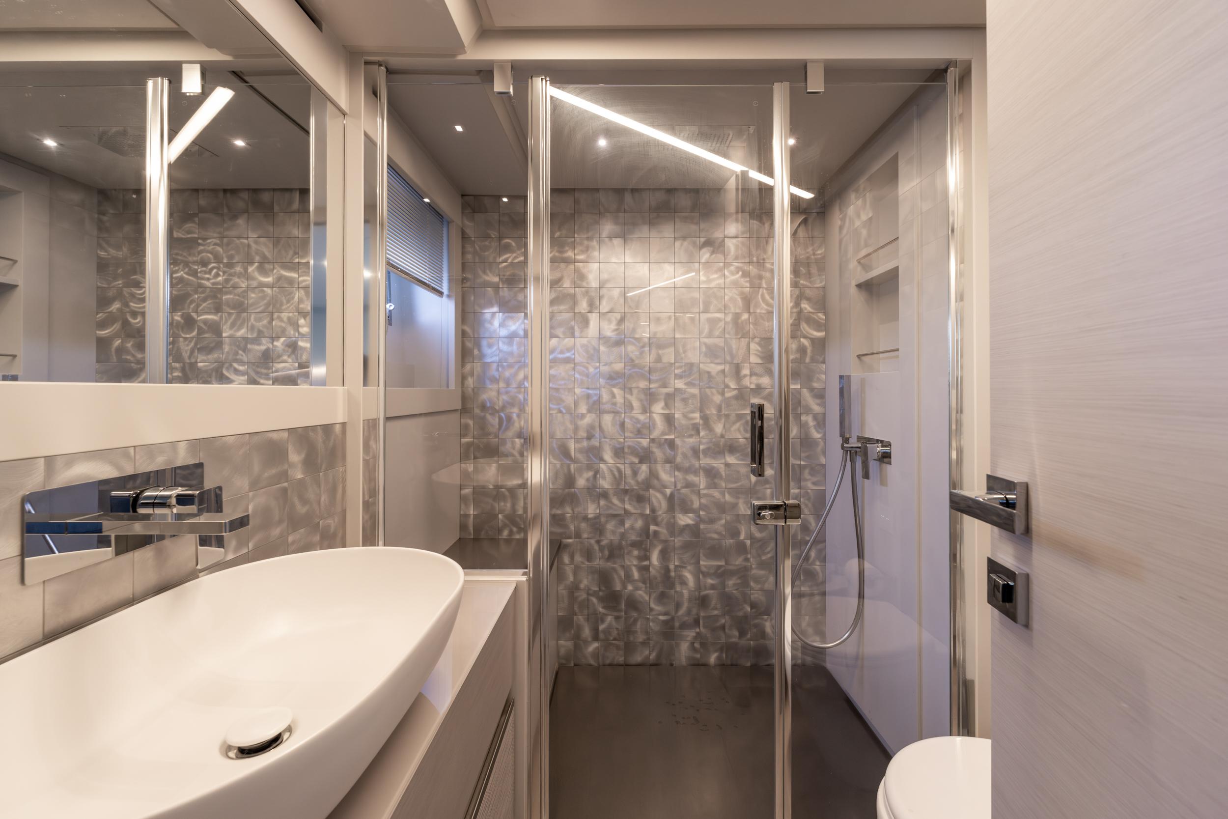 Luxurious bathroom interior of 2024 Pershing 7X yacht with modern fixtures and elegant design.