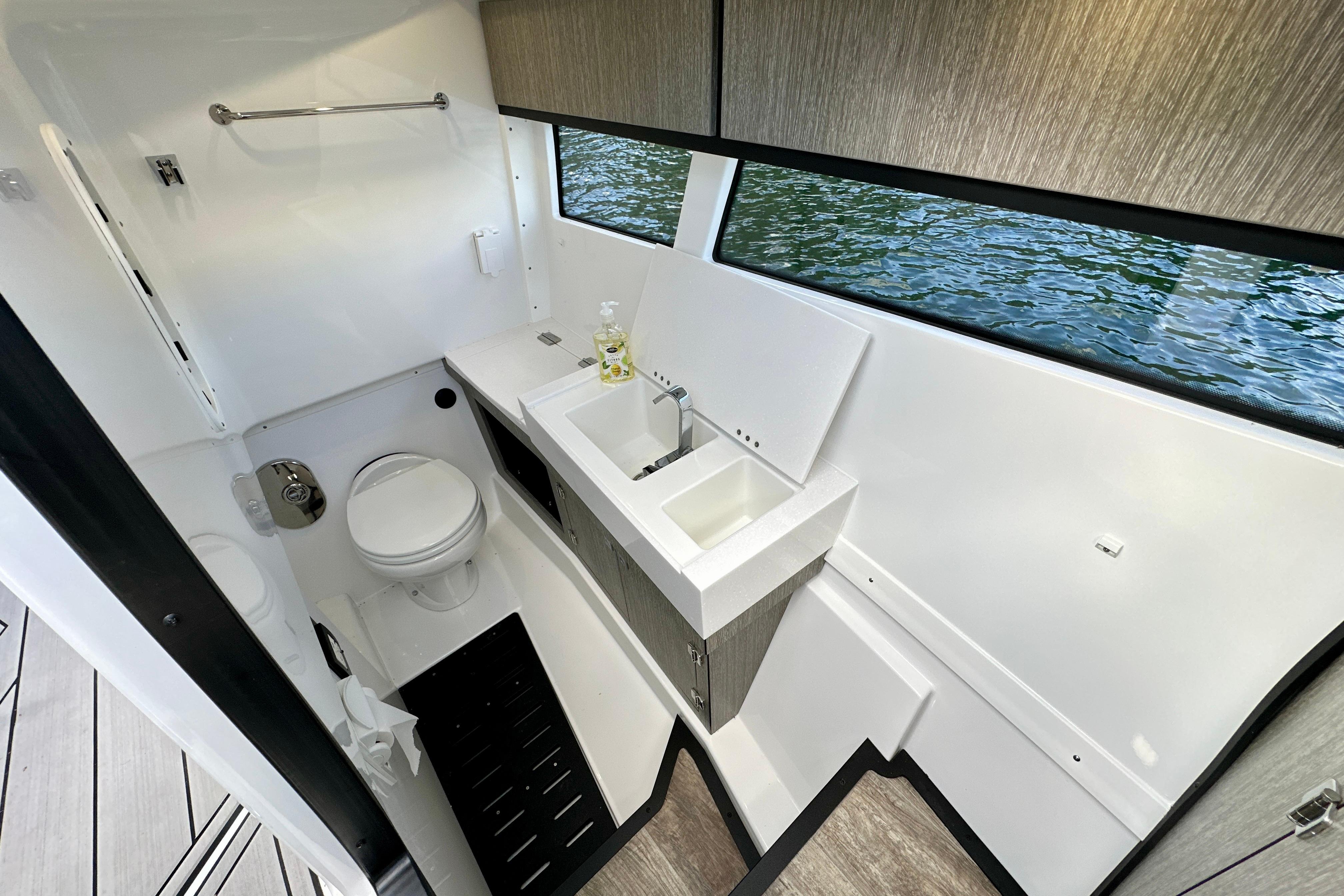 2022 Monterey 378SS Super Sport boat bathroom with modern sink and toilet, overlooking water.
