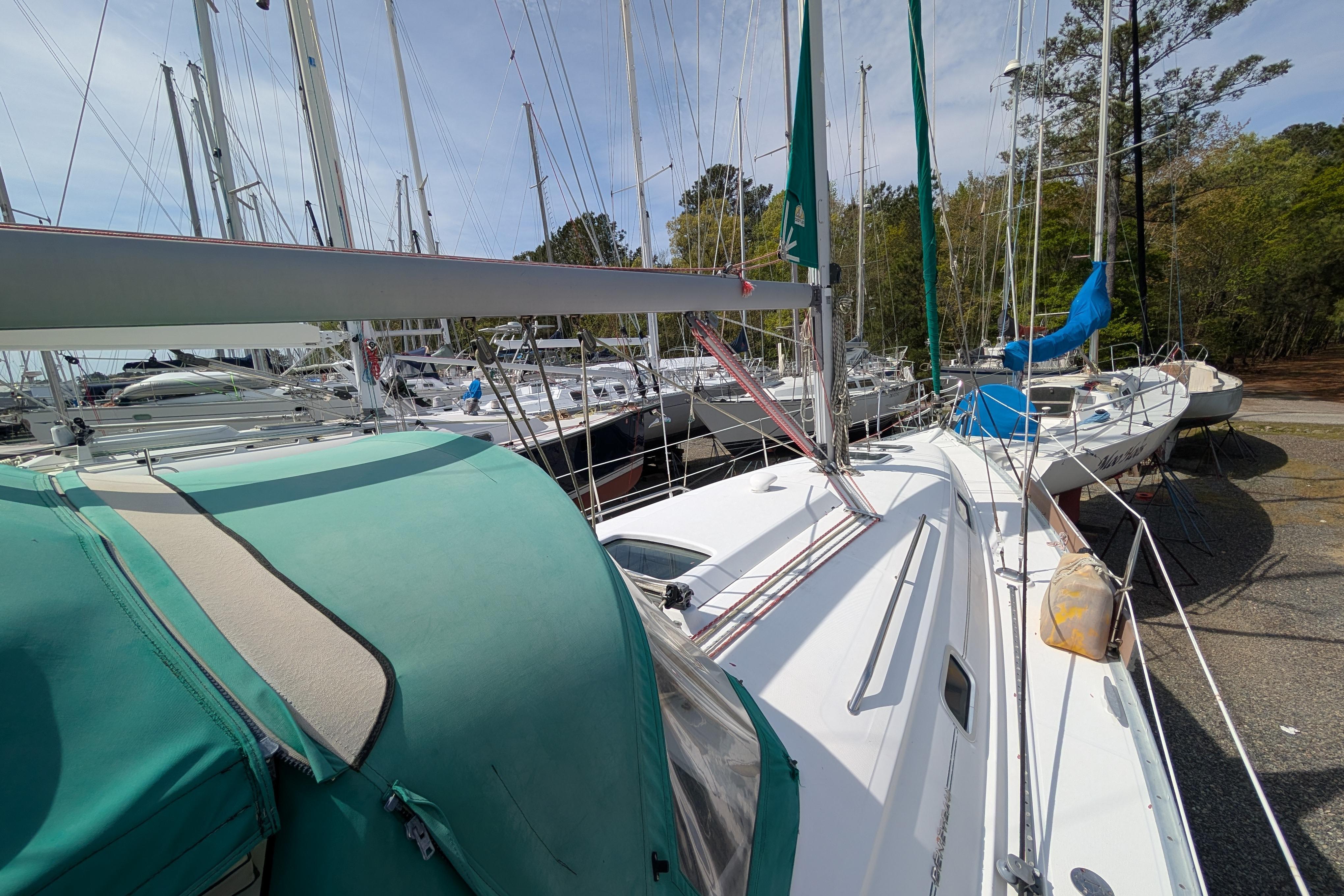 2003 Beneteau 331 sailboat docked among other vessels in a marina.