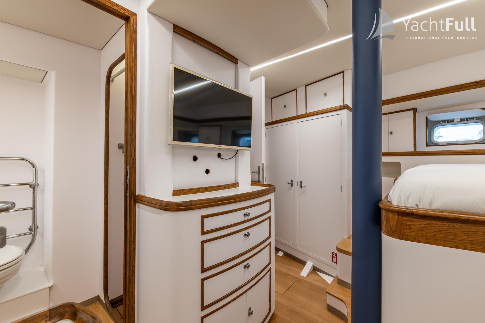 Luxurious interior of 1987 Nordia Van Dam 82 ketch yacht with modern amenities and elegant wood finishes.