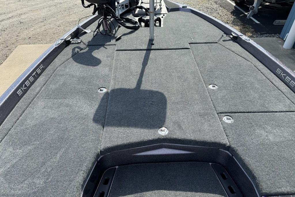 2026 Skeeter ZXE20 boat deck with gray carpeting and fishing equipment.