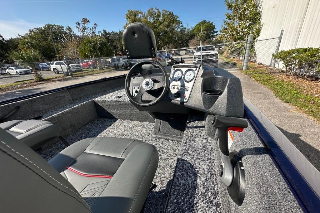 2026 Tracker Pro Guide V-16 SC boat interior with steering console and seating.