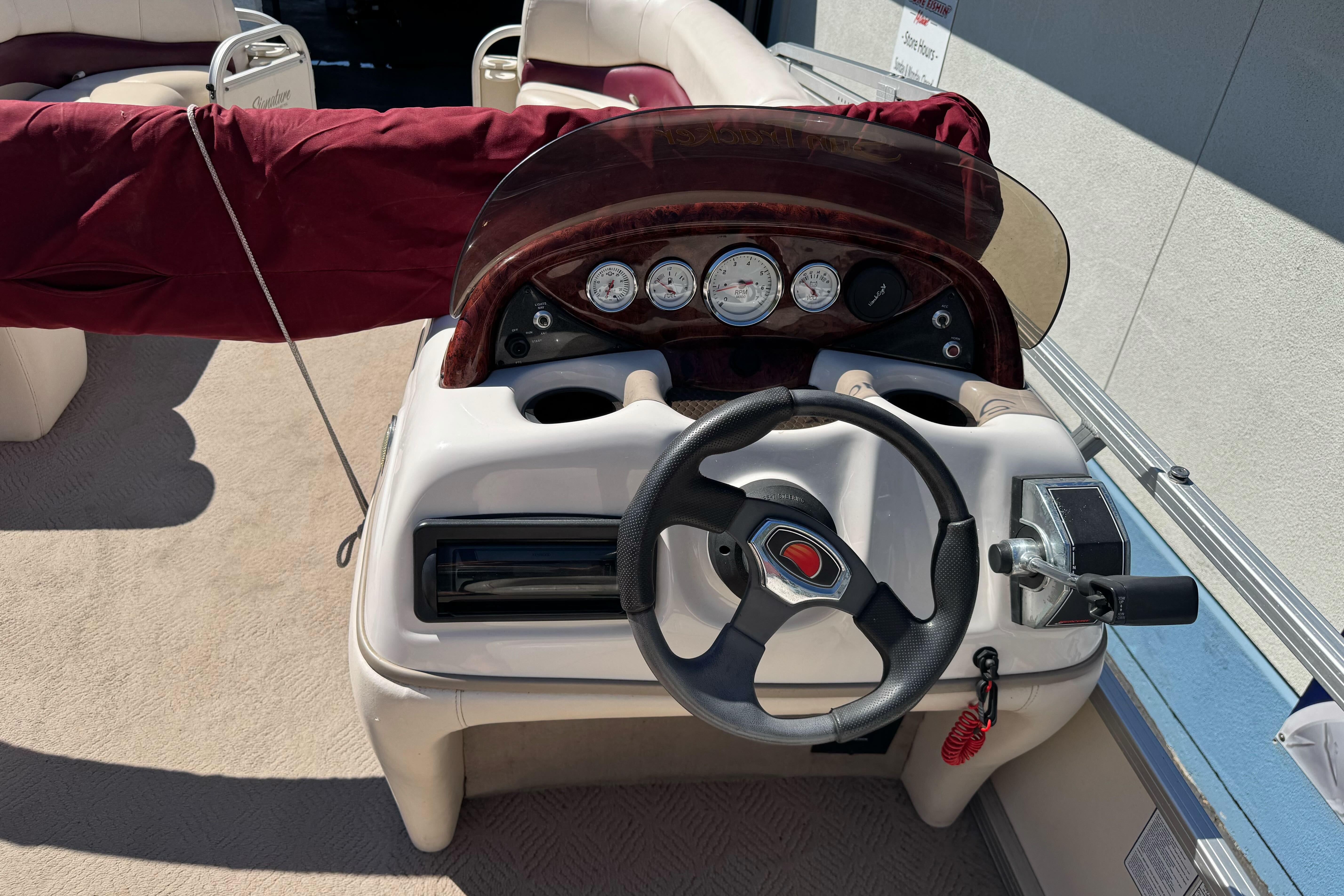 Steering console of a 2011 Sun Tracker Party Barge 21 pontoon boat.