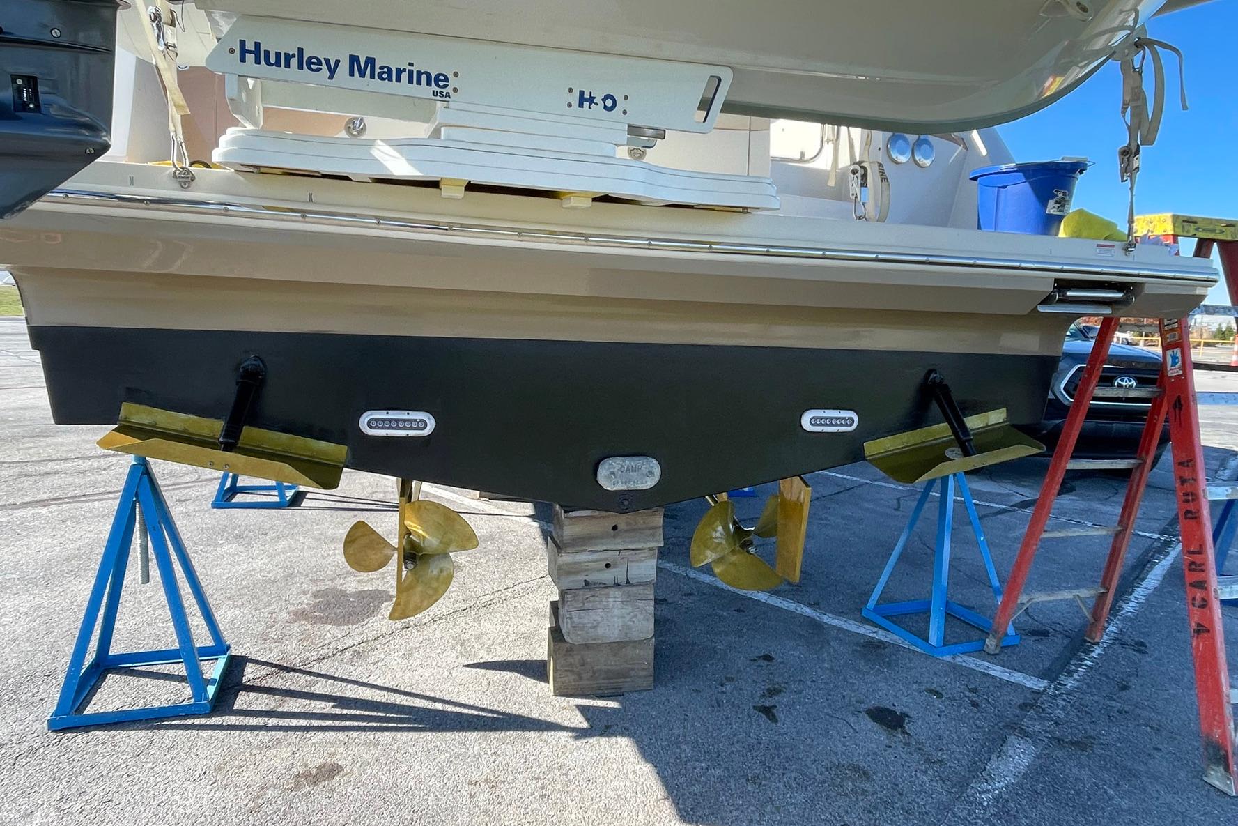 2013 Carver C34 boat on stands, showing propellers and hull details.