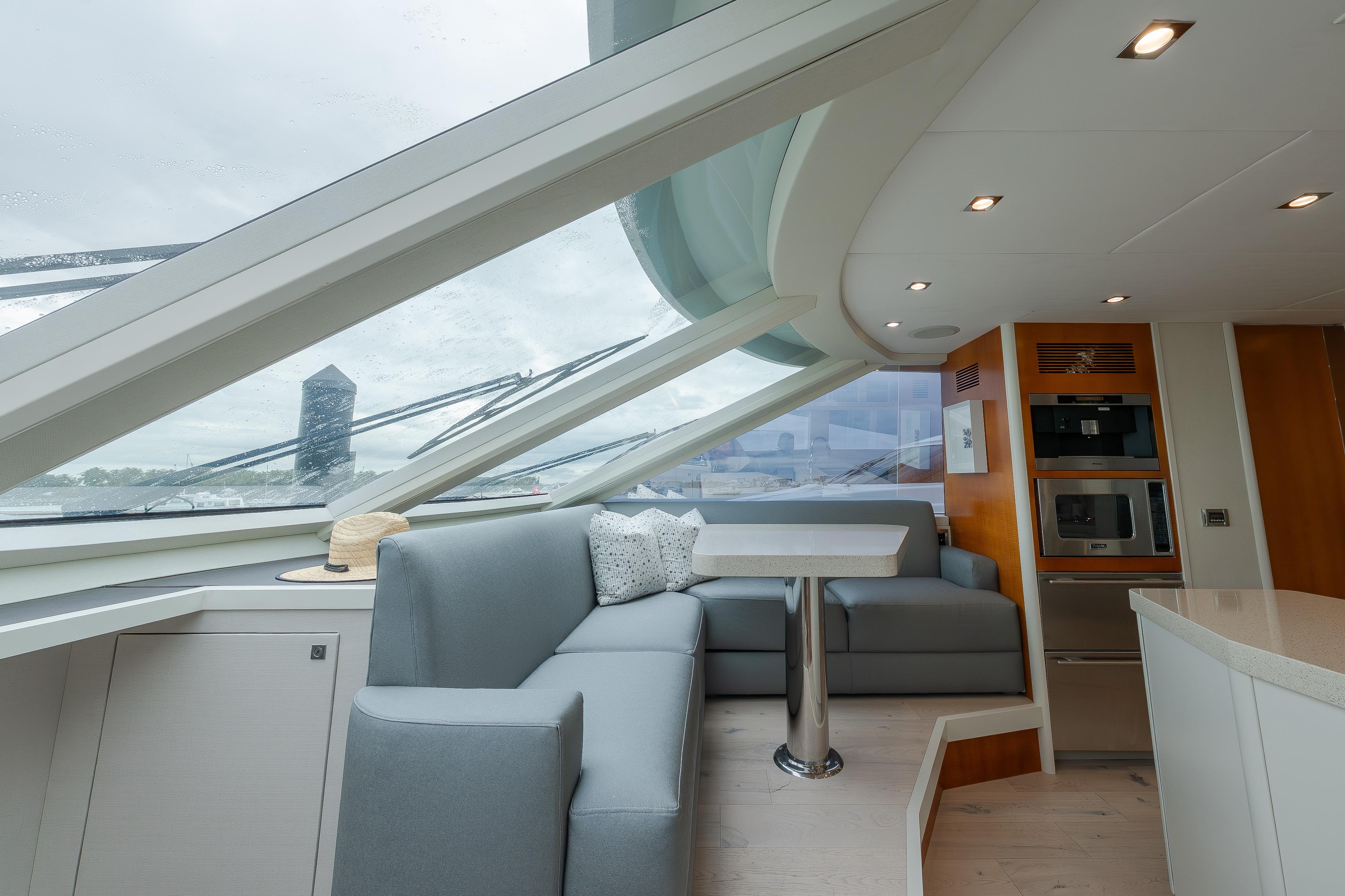 Luxurious interior of 2012 Lazzara Breeze yacht with modern seating and panoramic windows.