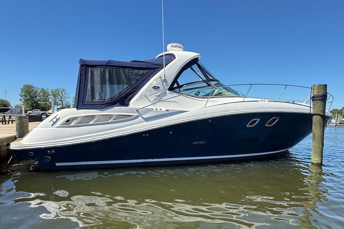 2008 Sea Ray Sundancer 330 yacht docked on calm water under clear blue sky.