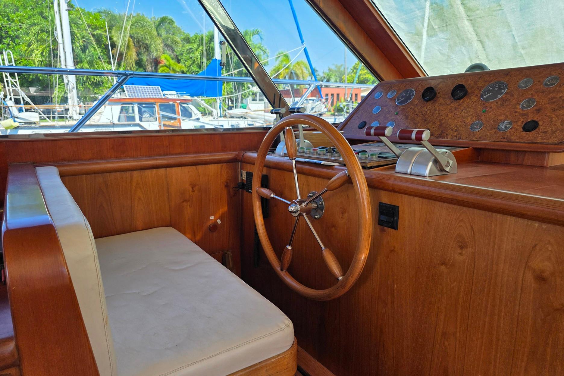Helm of 2001 Horizon Sundeck yacht with wooden steering wheel and control panel.