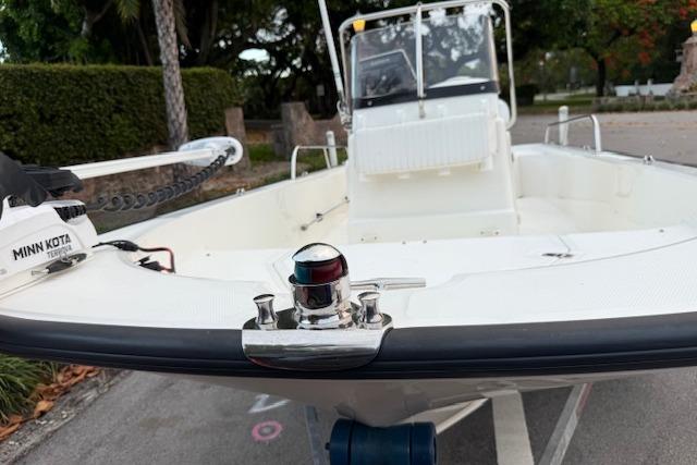 2016 Boston Whaler 150 Montauk boat with Minn Kota trolling motor, parked on a trailer.