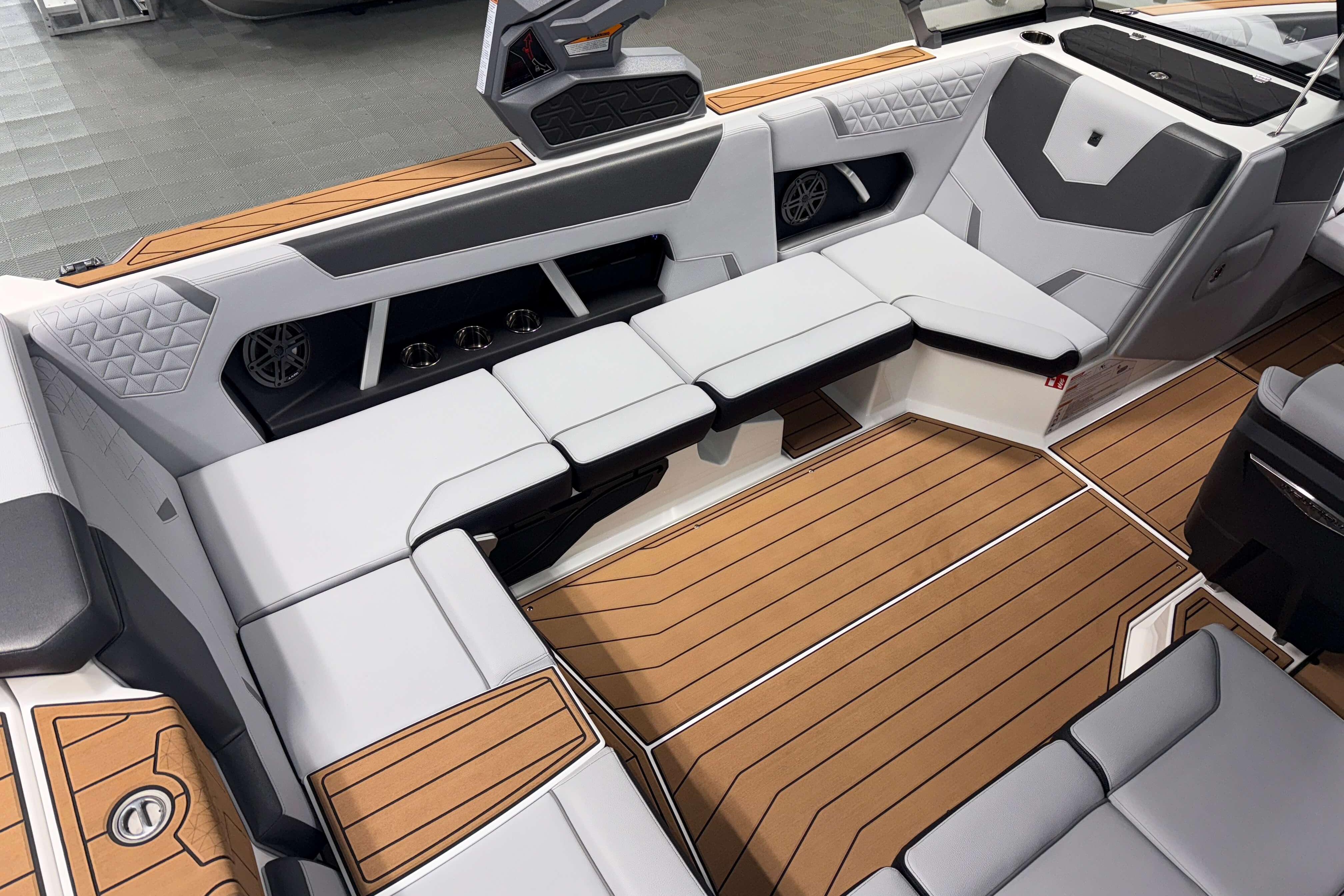 2026 Nautique Super Air Nautique GS22 interior with luxurious seating and teak-style flooring.