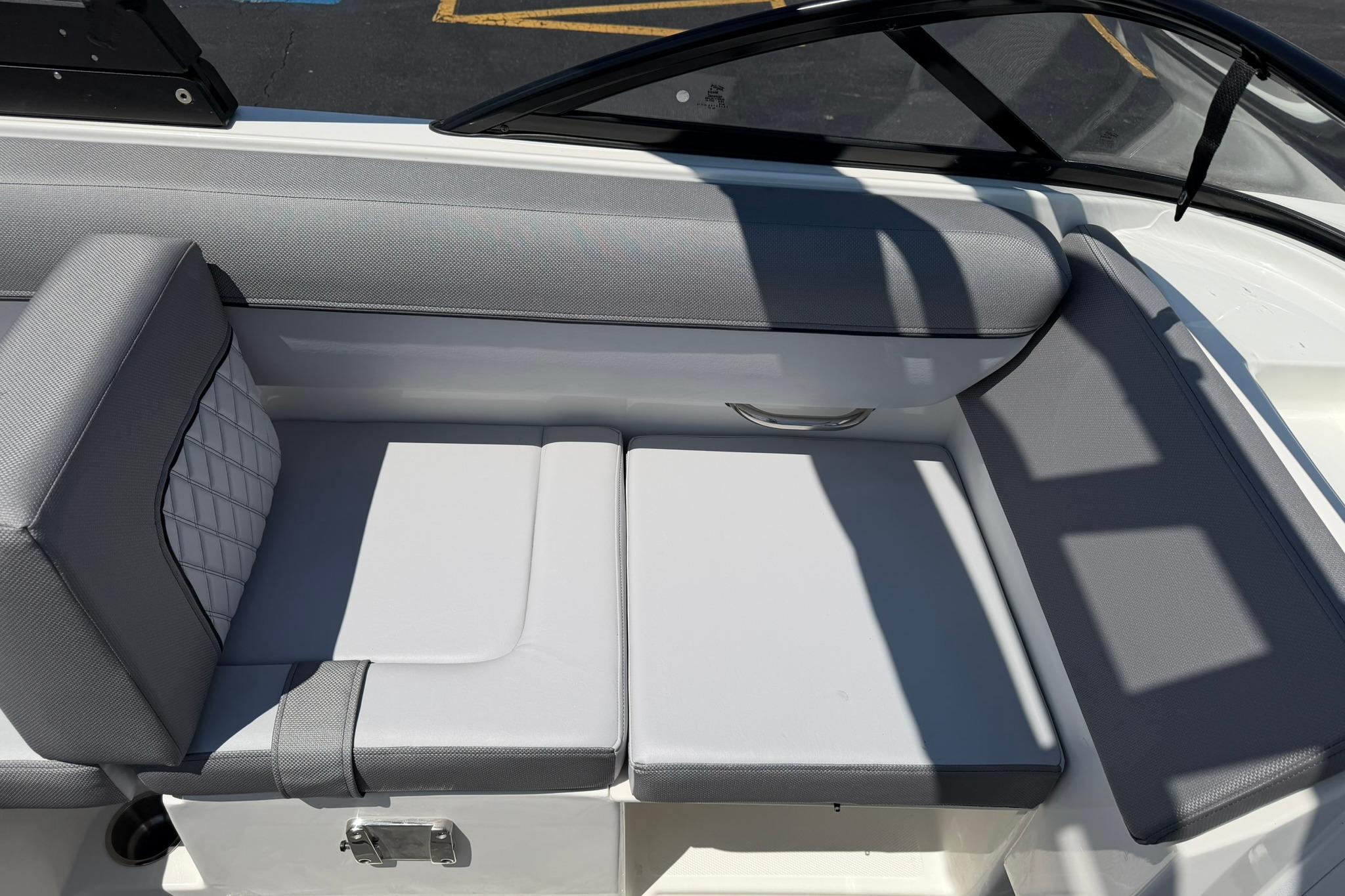 2026 Bayliner D20 boat interior with gray cushioned seating and sleek design.