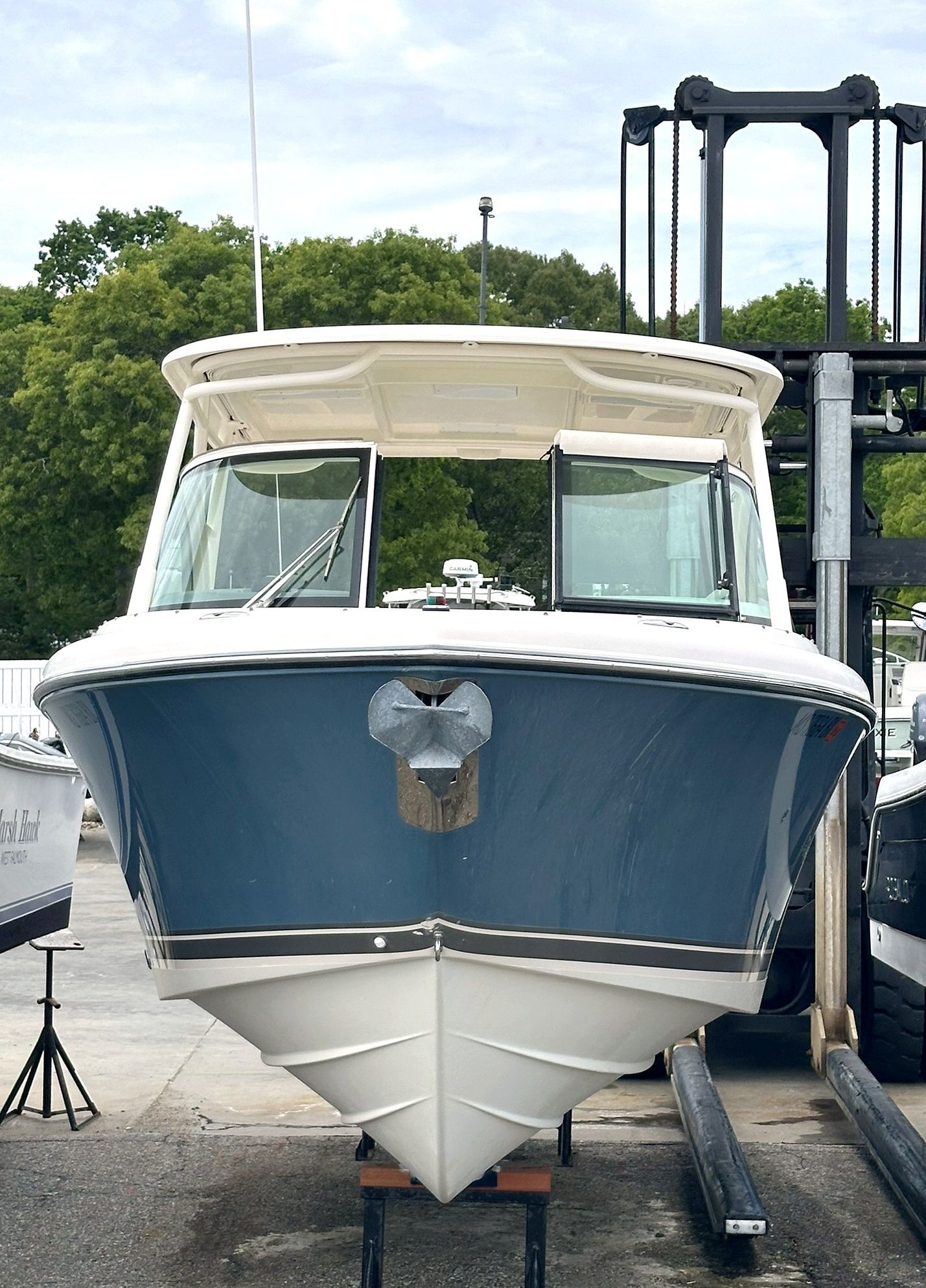 2012 Pursuit DC 265 Dual Console boat on a dock.