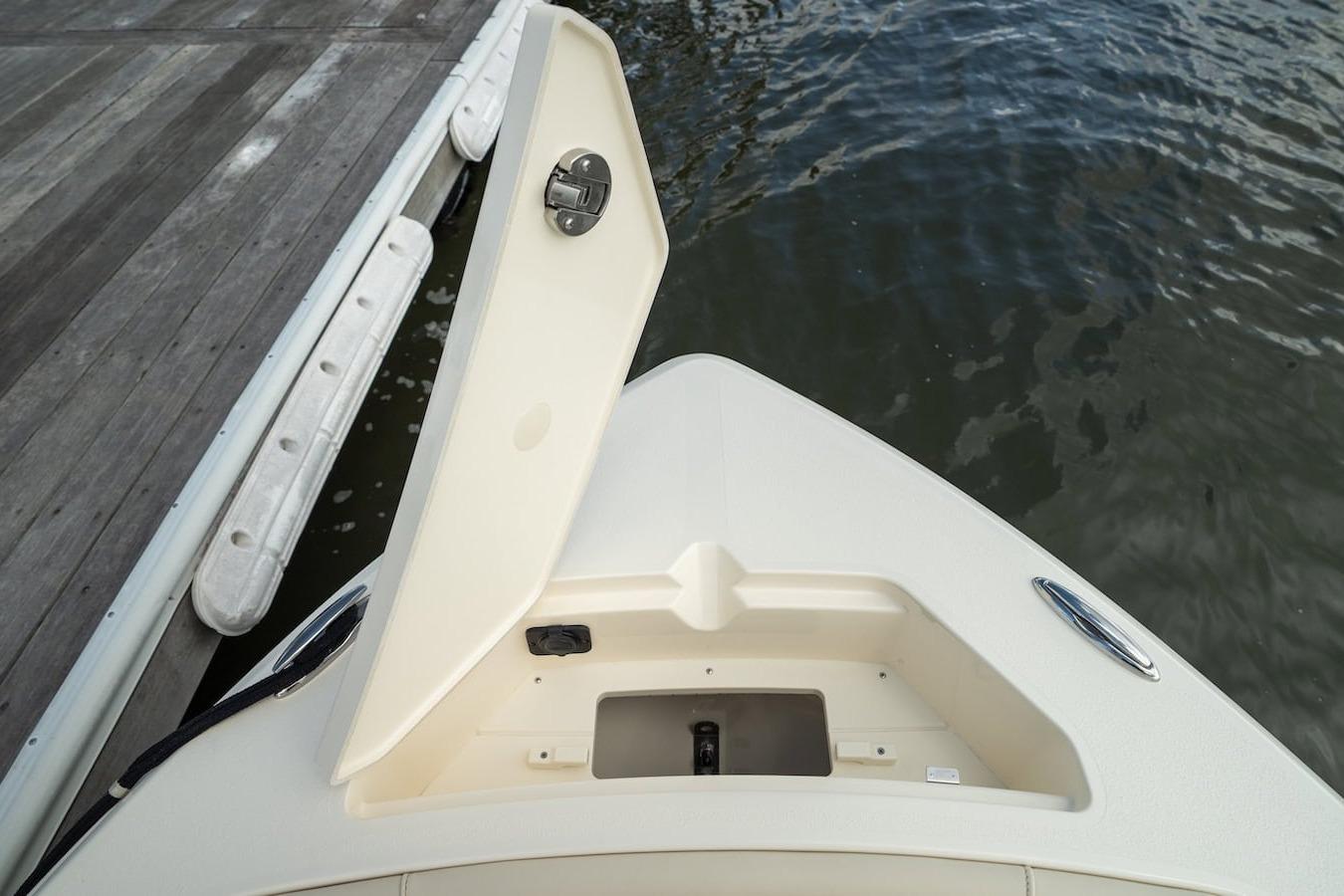 Bow view of 2026 Scout 188 Sportfish boat docked by the water.