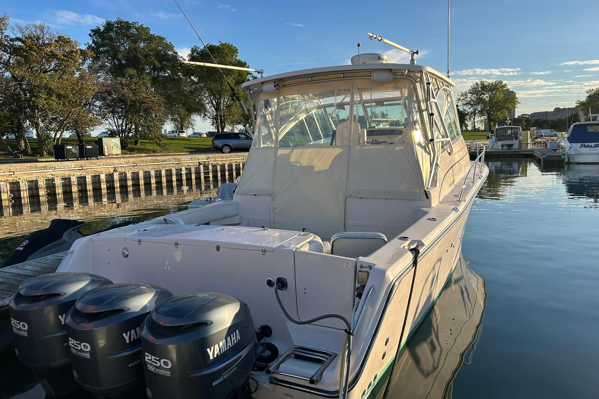 2007 Grady-White Express 360 boat docked with Yamaha engines, calm water, and clear sky.