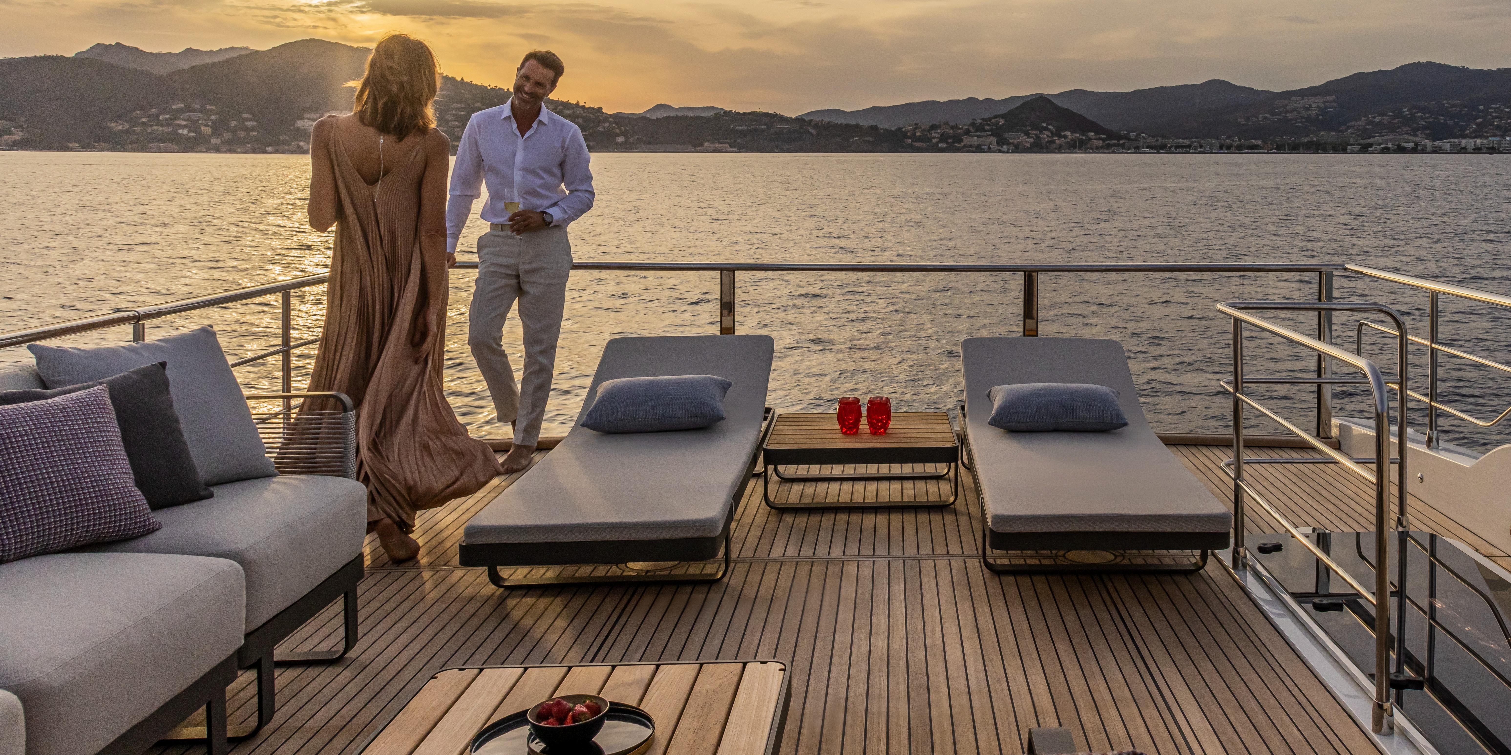 Couple enjoying sunset on Absolute NAVETTA 75 yacht deck, 2025 model.
