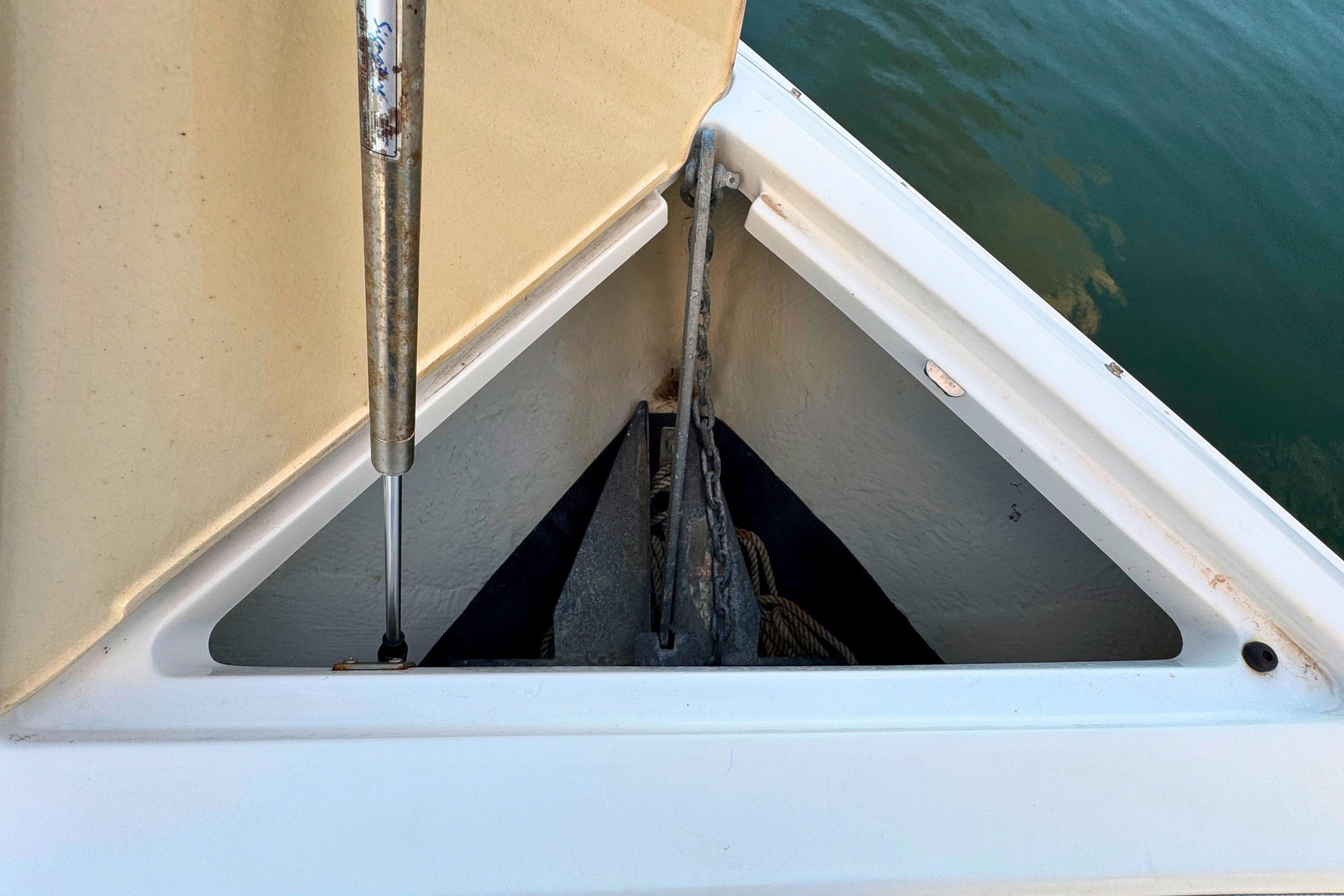 2019 Cobalt R3 boat anchor compartment with hydraulic lift, near water.