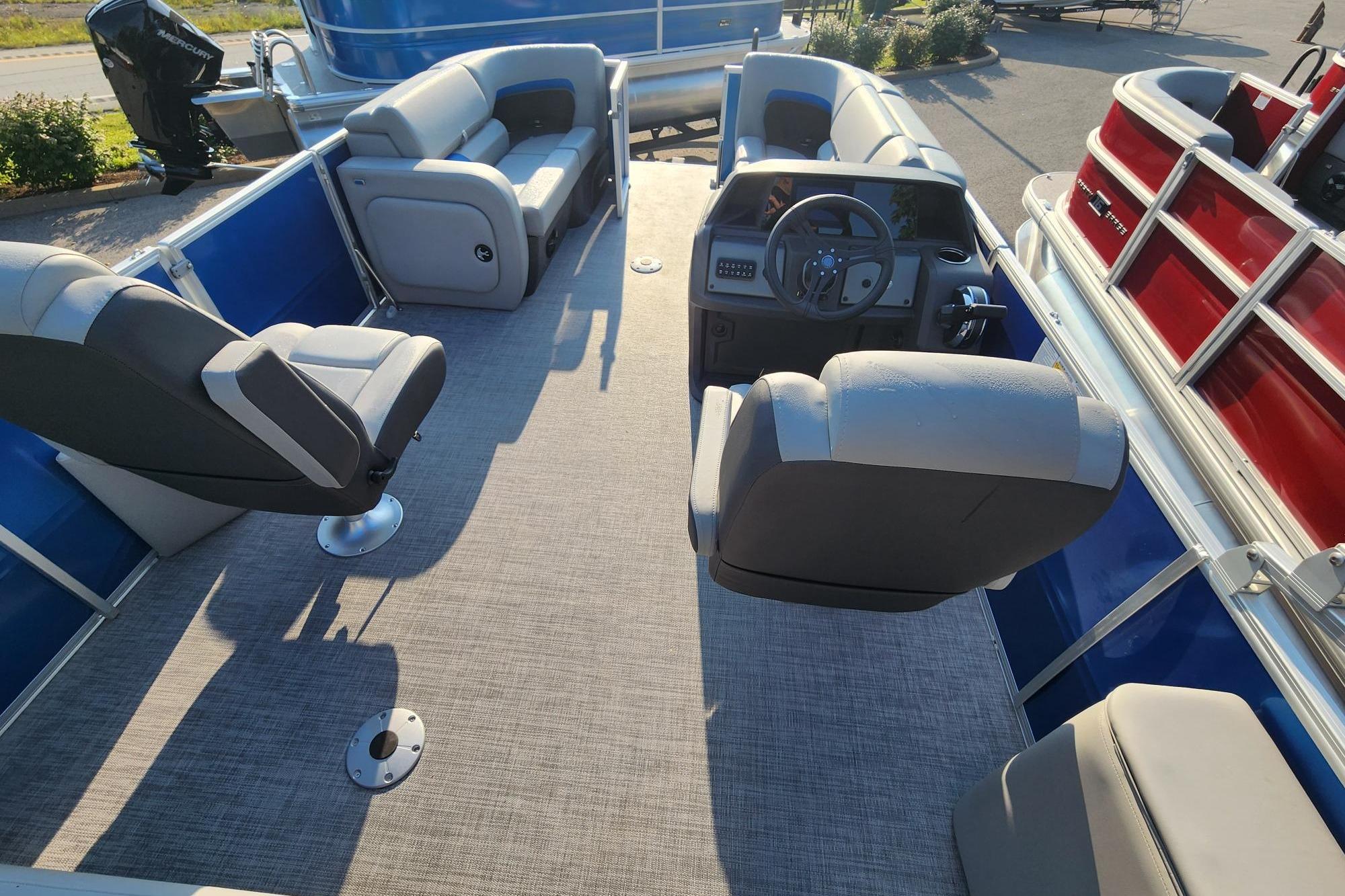 2026 Sun Tracker Party Barge 22 RF DLX interior with seating and steering console.