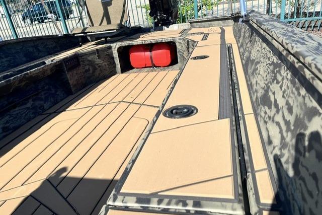 2026 Tracker Grizzly 1756 T Marsh boat interior with camouflage design and tan flooring.