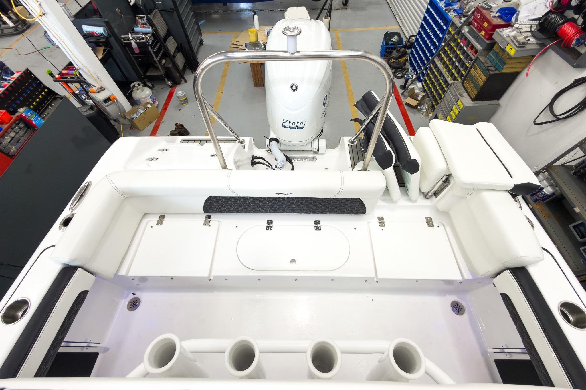 The image shows the cockpit of a Tidewater 220 LXF boat with an outboard motor.
