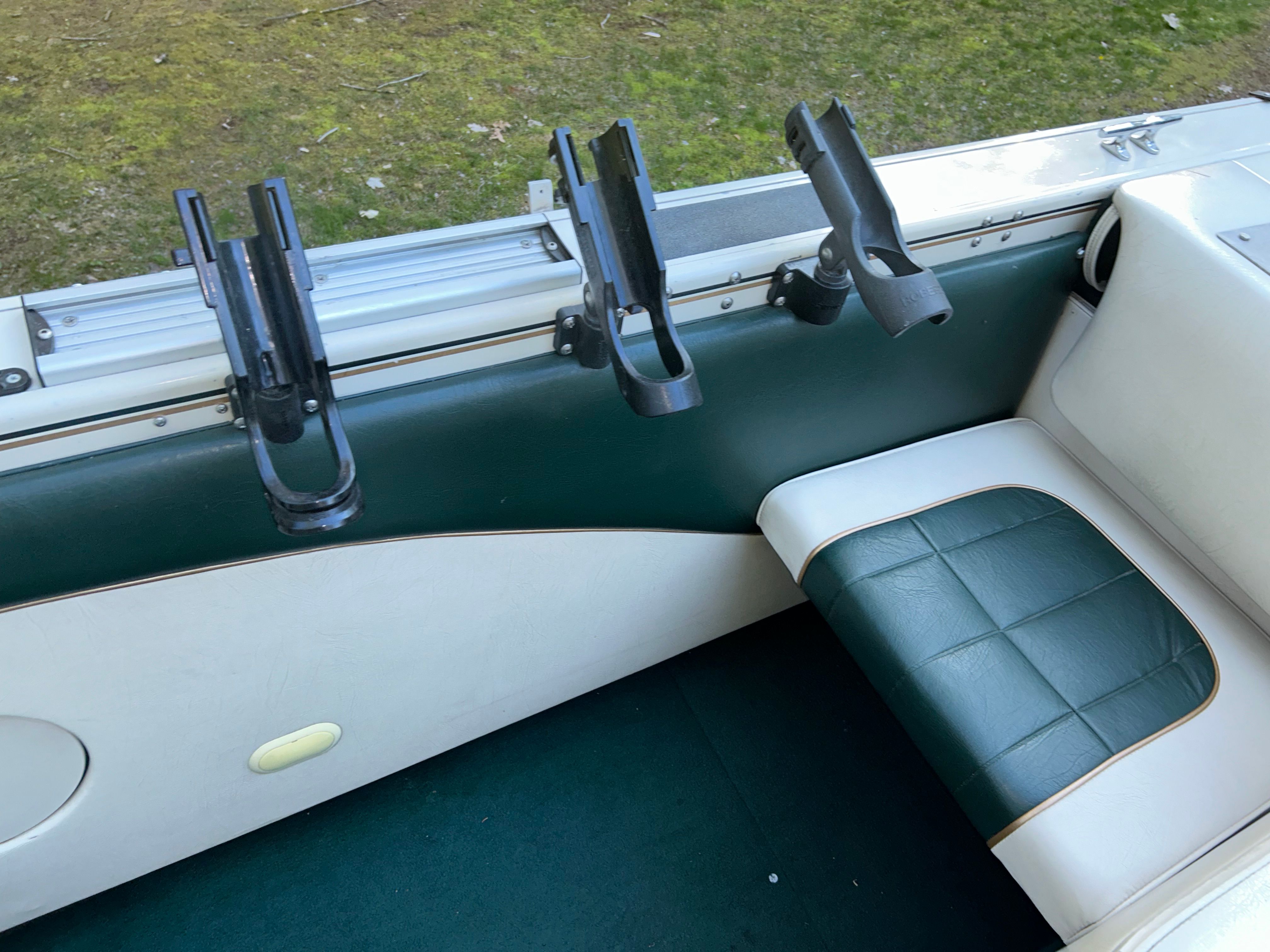 Interior of a 1997 Crestliner 2050 Sportfish with fishing rod holders.