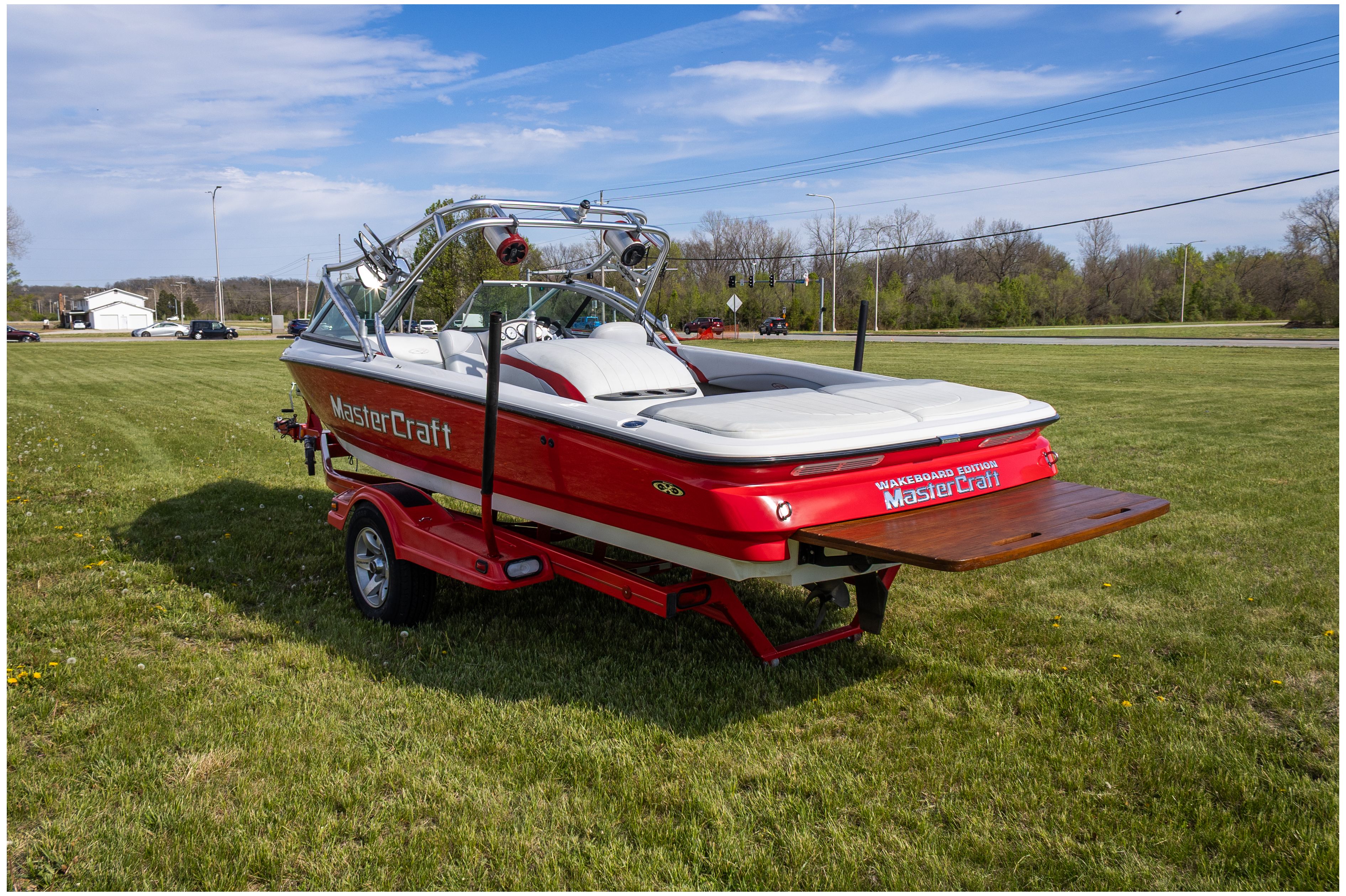 2002 MasterCraft X-7 boat parked outdoors on trailer.