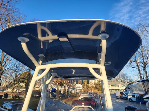 2021 NauticStar 2302 Legacy boat with T-top in a marina.
