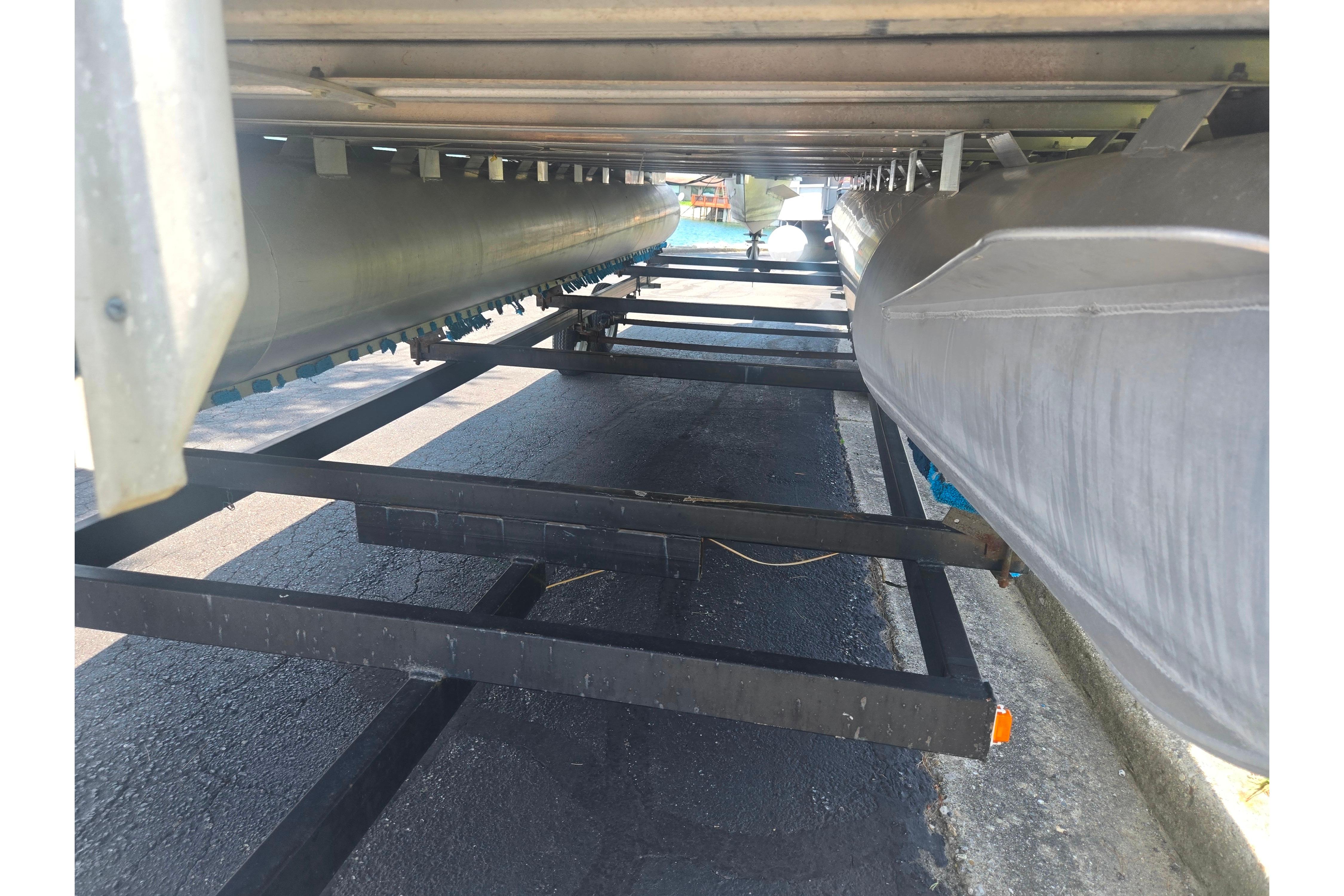 Underneath view of a 2000 Sylvan 824 Elite Cruise pontoon boat on a trailer.
