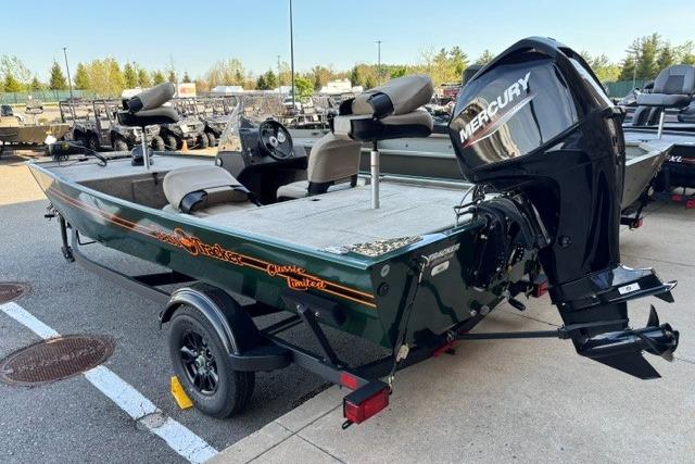 2026 Tracker Bass Tracker Classic Limited boat with Mercury engine, parked outdoors.