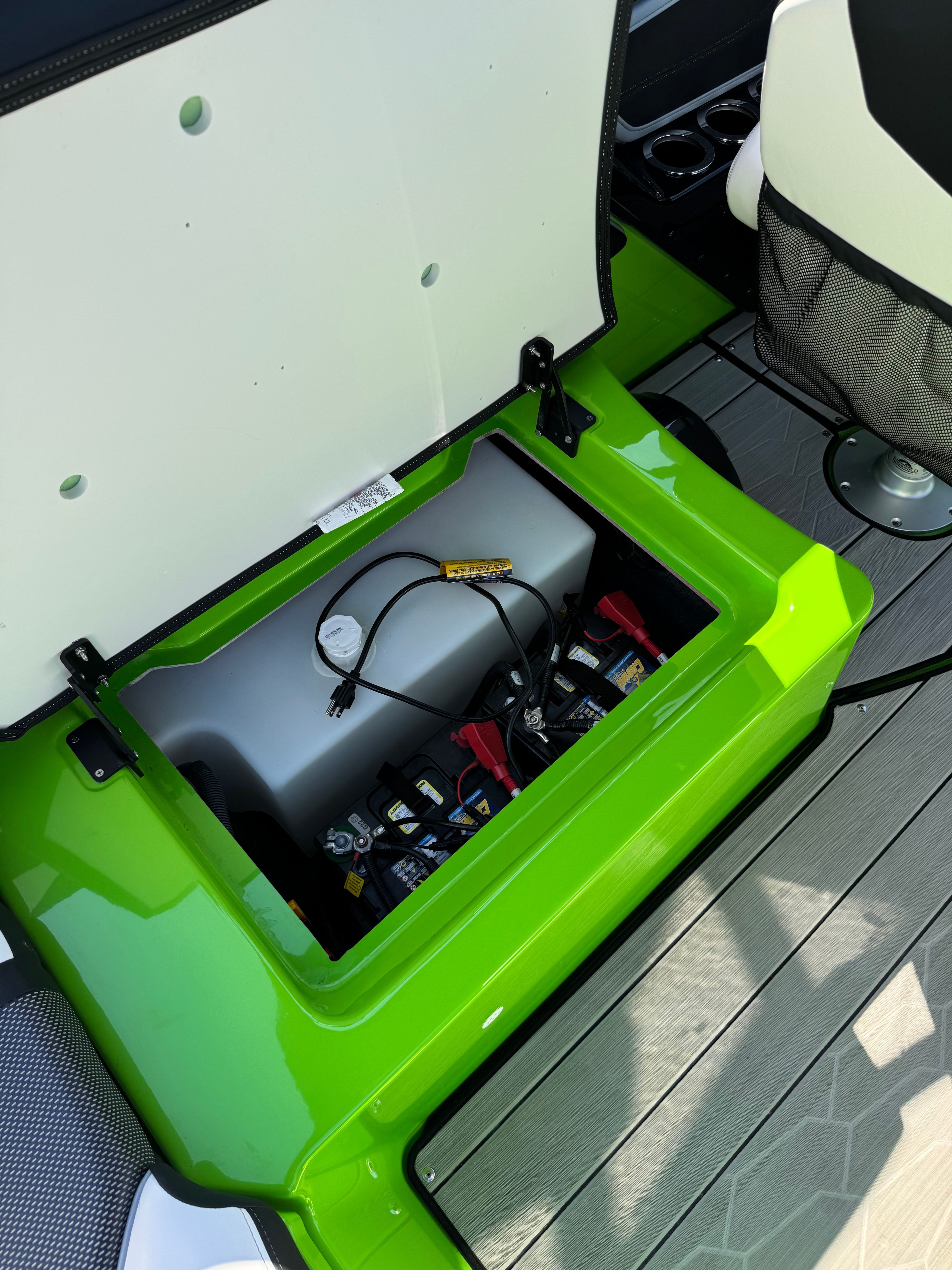 Battery compartment of a 2022 Yamaha Boats 255XD with a green casing.