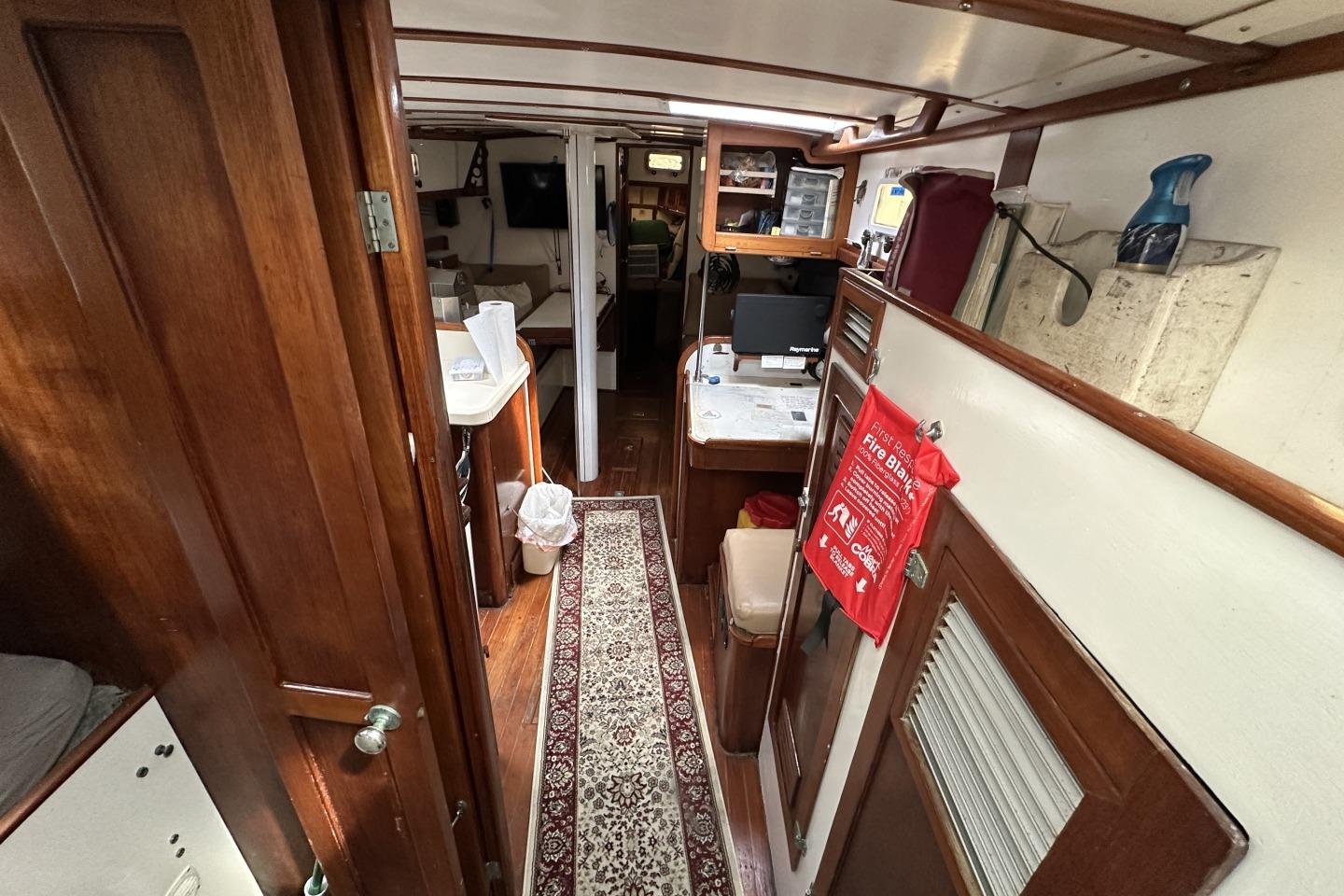 1976 Valiant 40 yacht interior with wooden cabinetry and nautical decor.