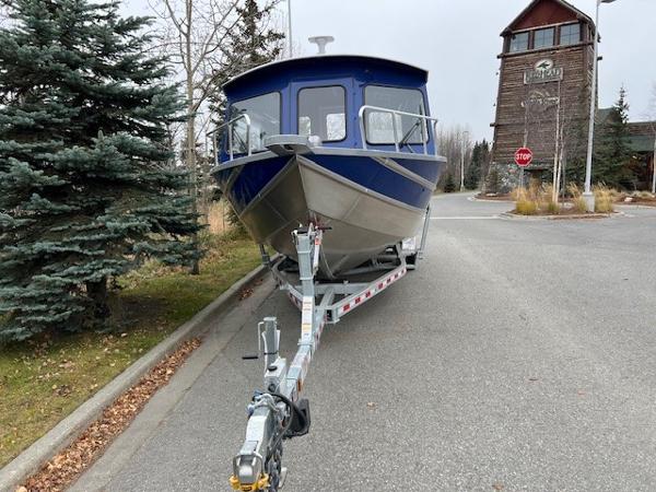 2024 Spartan 26 Maximus Pro XL boat on trailer, parked on a suburban street.
