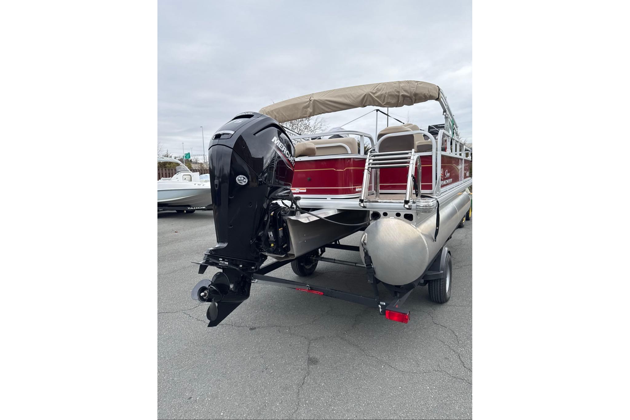 2024 Sun Tracker Bass Buggy 18 DLX pontoon boat with outboard motor, rear view.