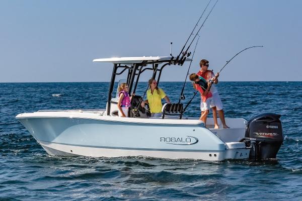 Manufacturer Provided Image: 2025 Robalo R232 Explorer boat with family fishing on open water.