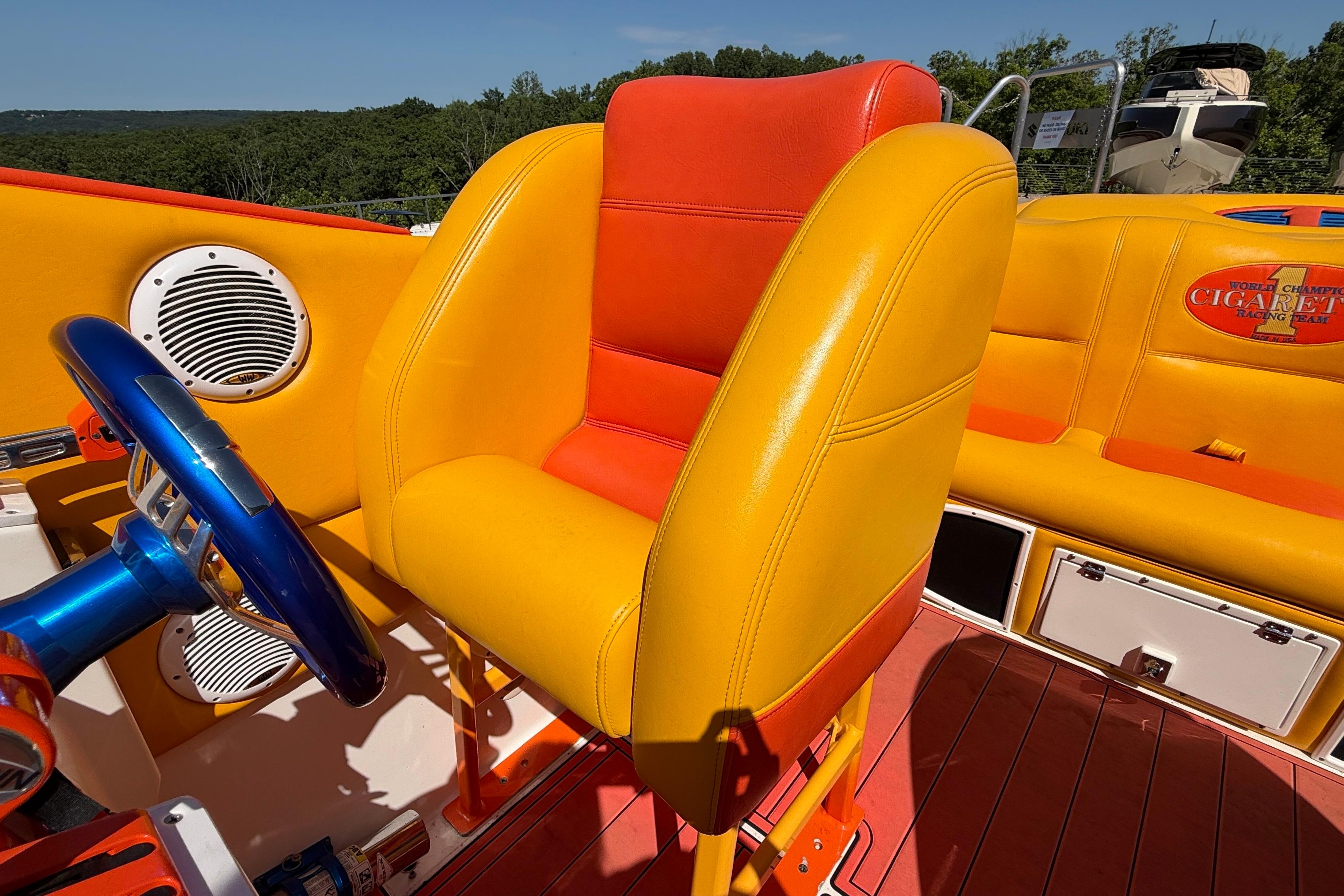 2002 Cigarette 35' Cafe Racer boat interior with vibrant yellow and orange seating.