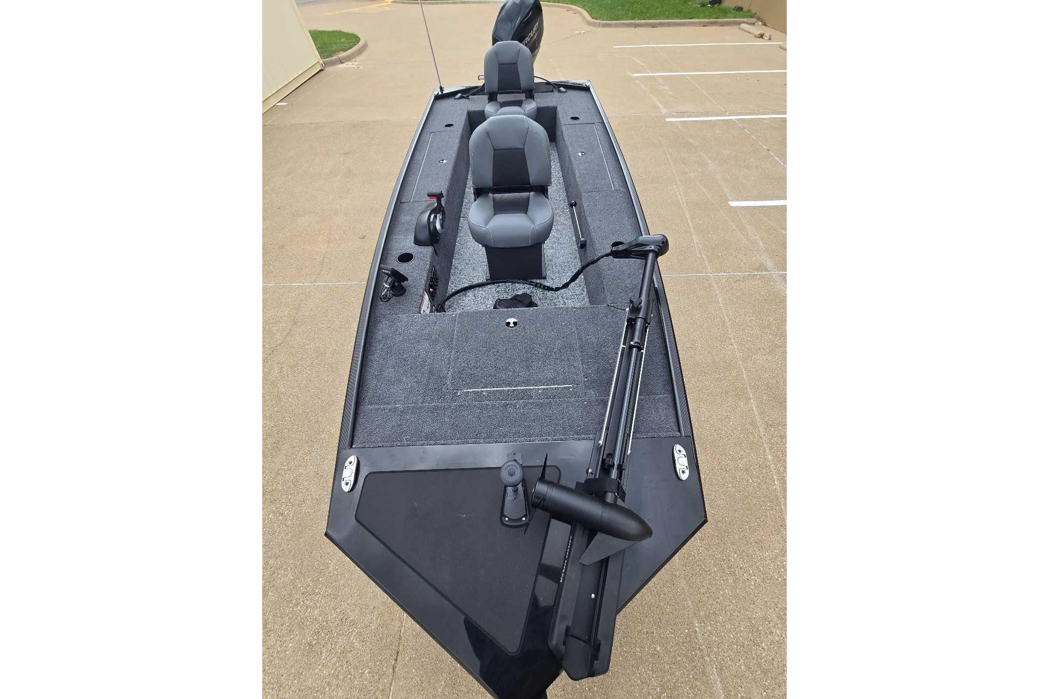 2026 Tracker Panfish 17 boat with dual seats and trolling motor on a concrete surface.