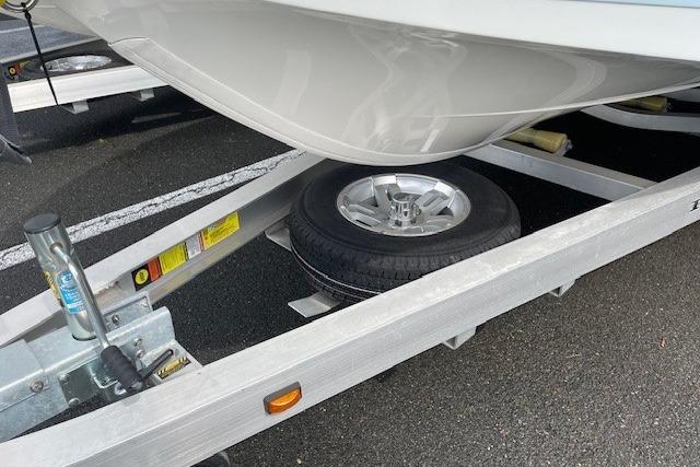 Ranger 2360 Bay 2025 on trailer with spare tire.