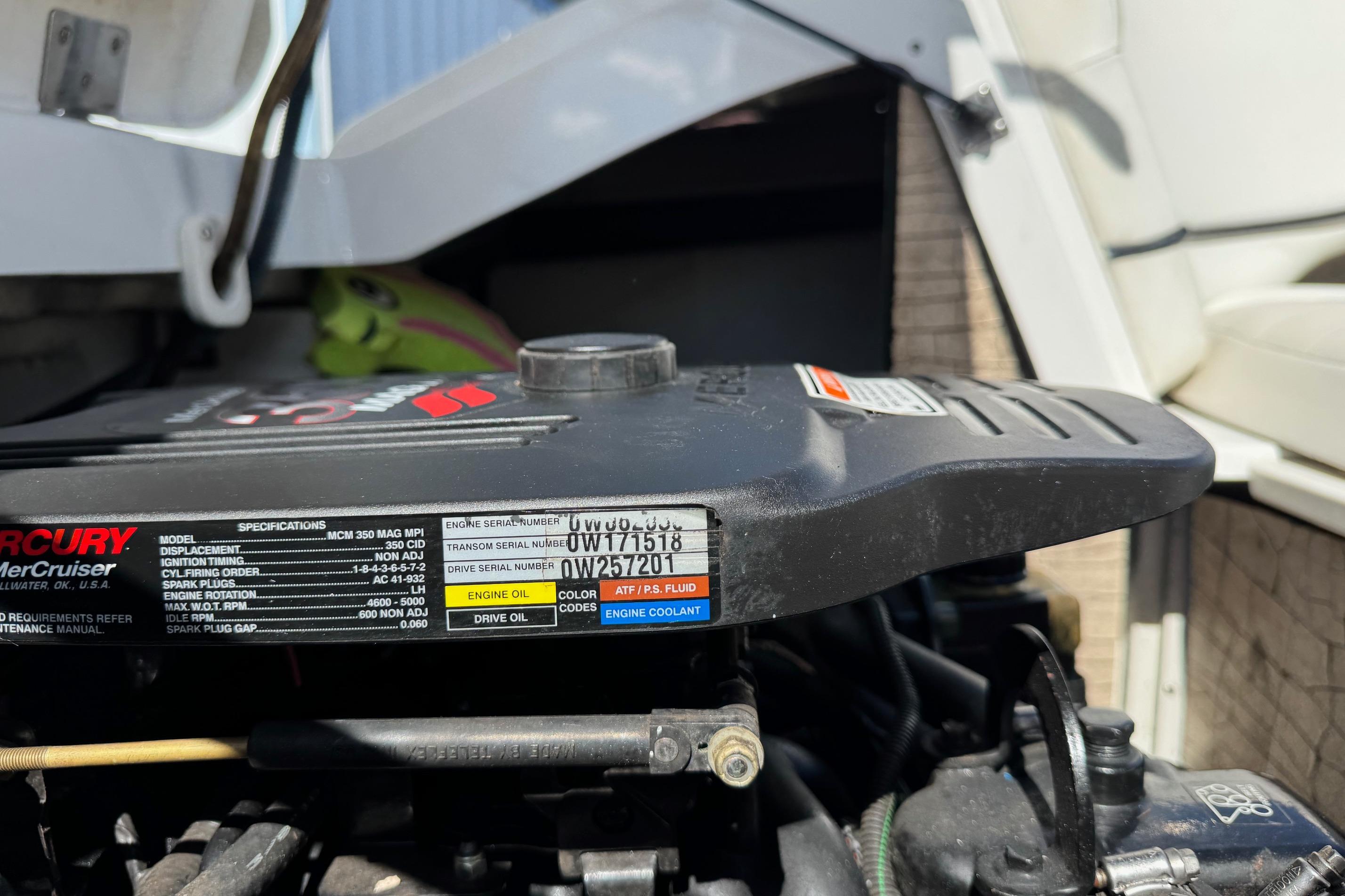 Engine compartment of a 2005 Cobalt 240 boat with visible specifications label.