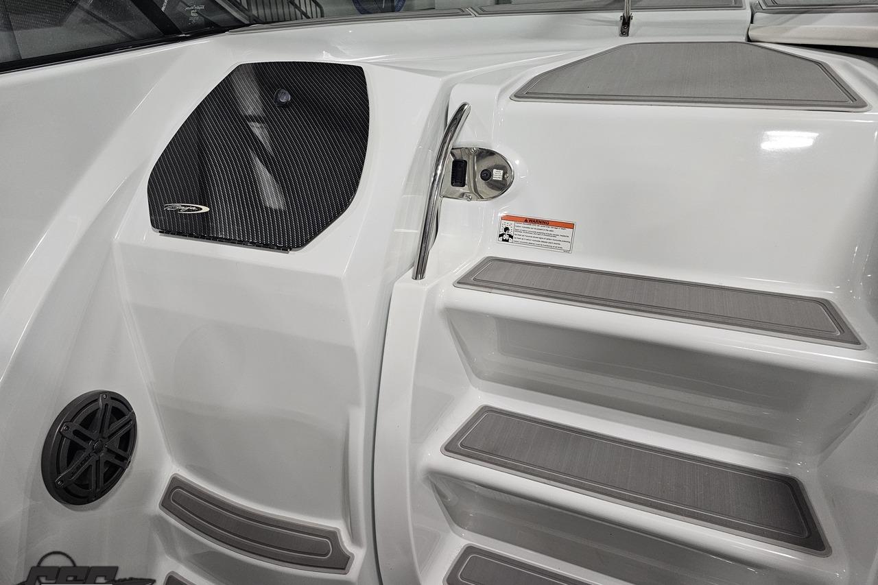 2008 Baja 335 Performance boat interior with sleek white steps and carbon fiber accents.