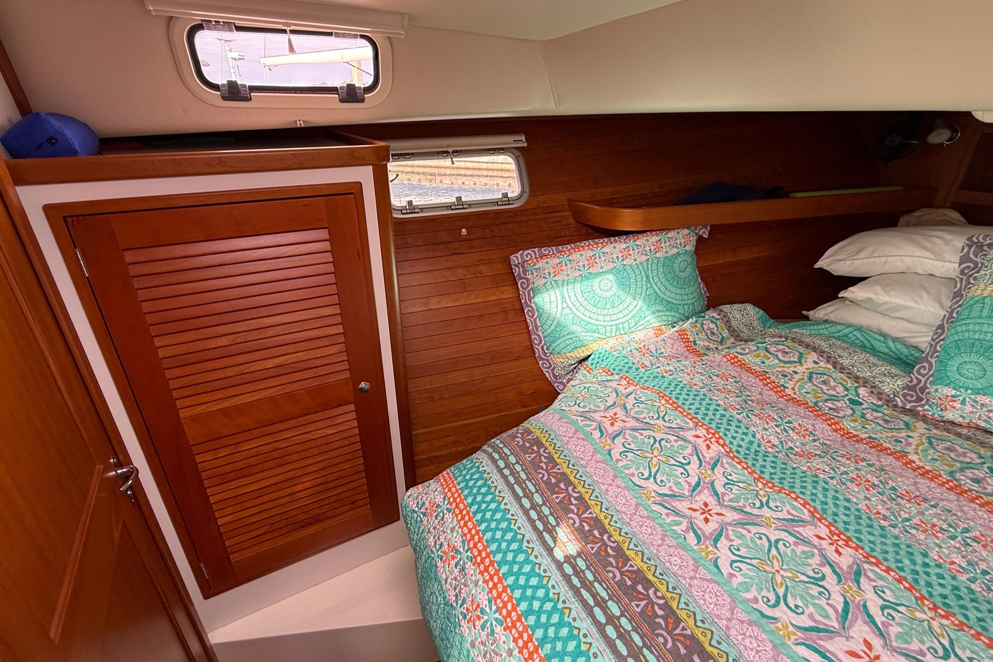 Cozy cabin interior of 2012 MJM 40z with colorful bedding and wooden accents.
