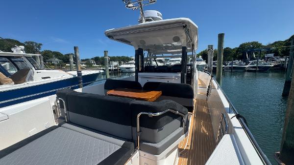 Luxurious 2025 Nimbus T11 boat docked, featuring spacious seating and sleek design.