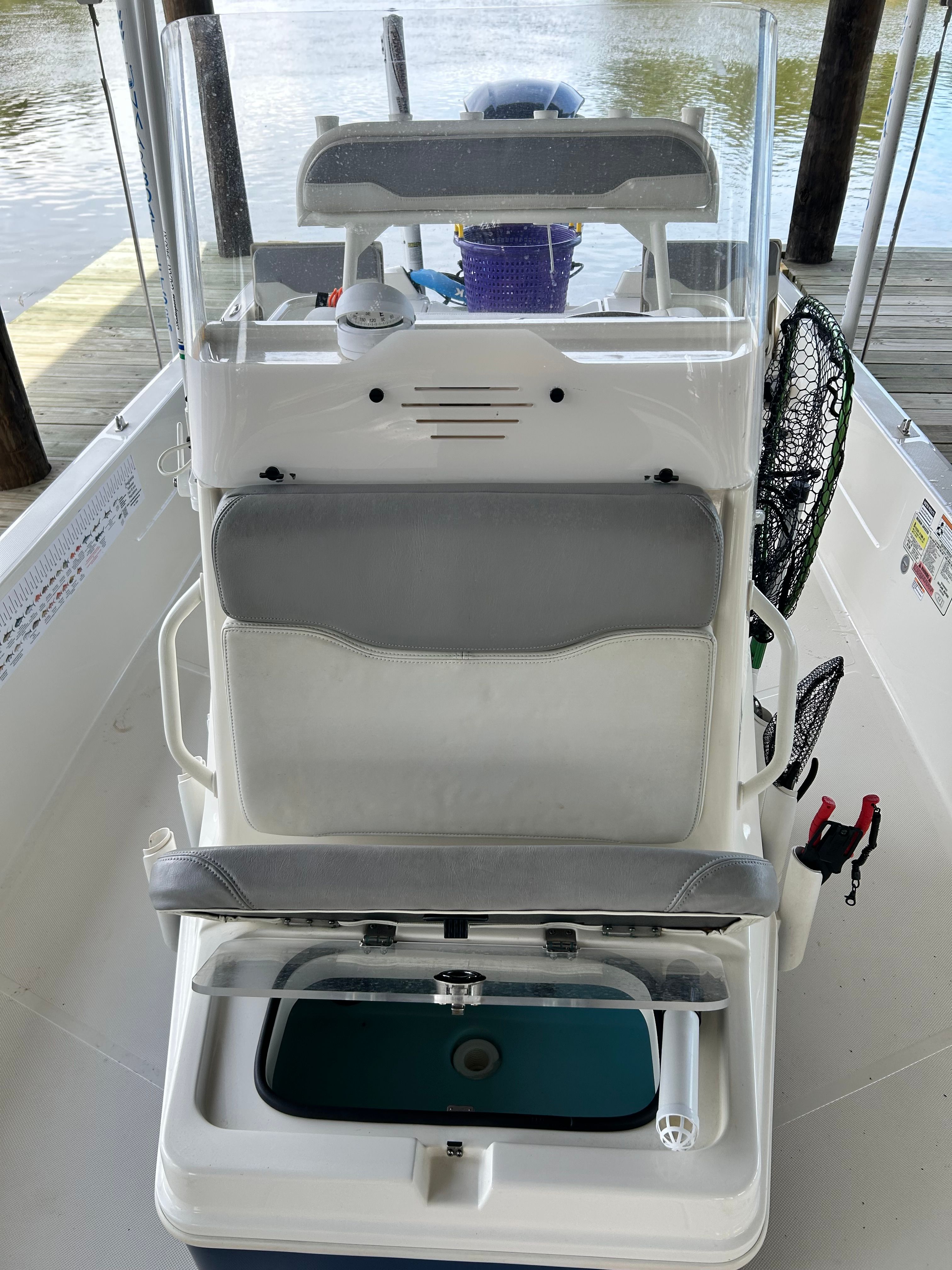 The image shows the cockpit of a 2016 Skeeter SX230 boat with gray seating.